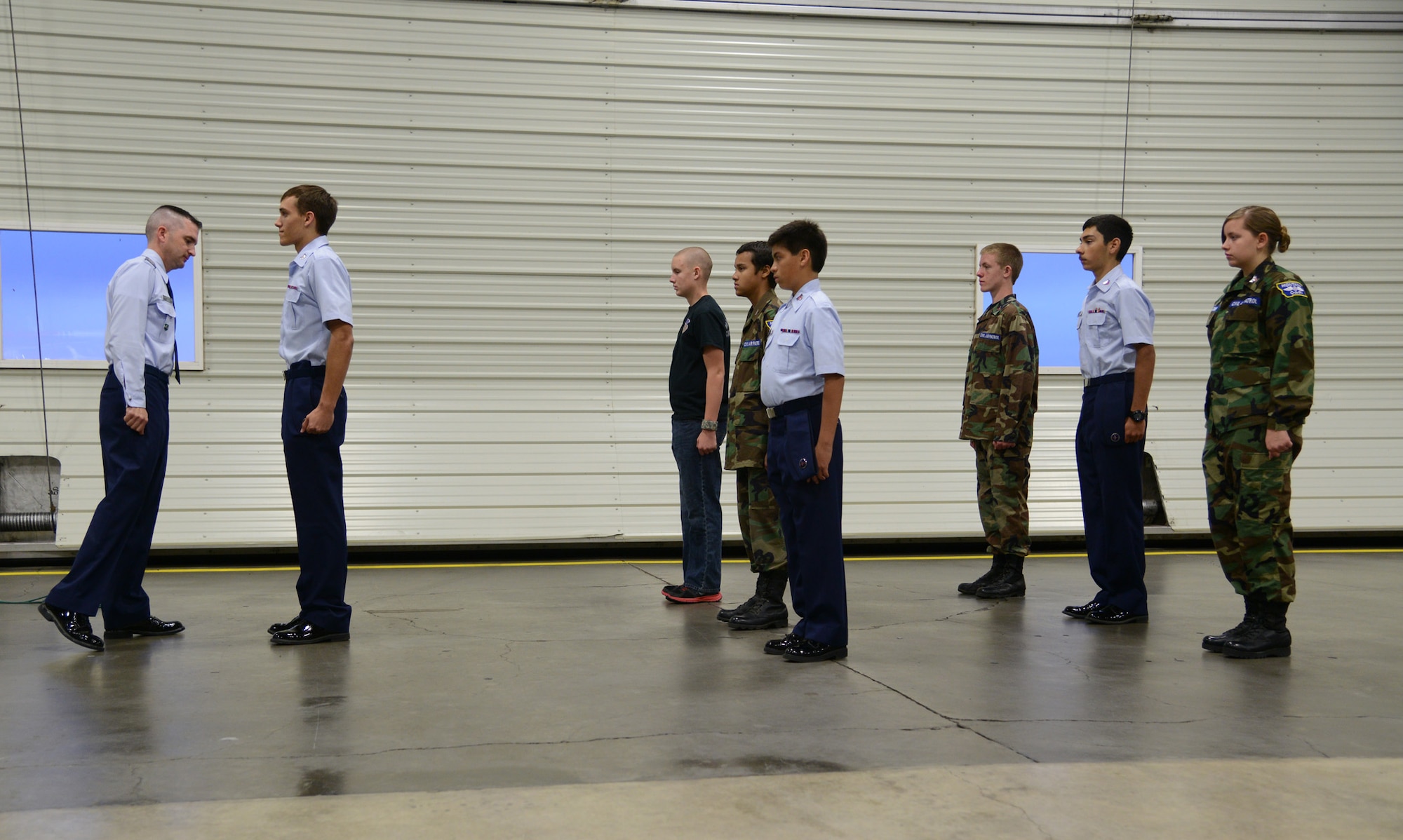 Staff Sgt. Jacob Webb, 341st Medical Operations Squadron dental craftsman and Malmstrom Air Force Base Civil Air Patrol Composite Squadron commander (far left) conducts a uniform inspection on cadet members during an open house on Sept. 17. Members of CAP who pursue a military career have prior knowledge of customs and courtesies, how to march and Air Force physical training requirements. (U.S. Air Force photo/Senior Airman Katrina Heikkinen)