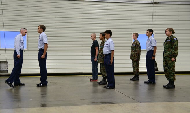 Staff Sgt. Jacob Webb, 341st Medical Operations Squadron dental craftsman and Malmstrom Air Force Base Civil Air Patrol Composite Squadron commander (far left) conducts a uniform inspection on cadet members during an open house on Sept. 17. Members of CAP who pursue a military career have prior knowledge of customs and courtesies, how to march and Air Force physical training requirements. (U.S. Air Force photo/Senior Airman Katrina Heikkinen)
