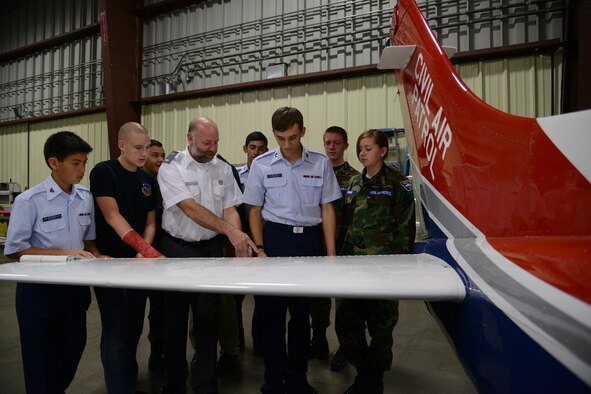 John Conner (center) Malmstrom Air Force Base Civil Air Patrol Composite Squadron deputy commander, explains the aerodynamics of a wing to cadets at Holman Aviation in Great Falls, Mont., during an open house on Sept. 17. The three missions of CAP are aerospace education, cadet programs and emergency services. (U.S. Air Force photo/Senior Airman Katrina Heikkinen)