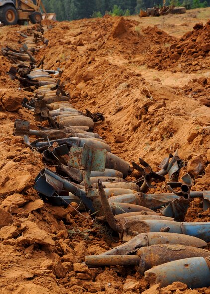 BDU-12s sit in a man-made trench waiting for Airmen from the 2nd Civil Engineer Squadron Explosive Ordnance Disposal flight to destroy and dispose of them at the Claiborne Bombing and Gunnery Range in Alexandria, La., Sept. 18, 2013. Using explosives, the BDUs are cracked open destroying the spotting cartridge inside. After the cartridge is destroyed, the BDUs can be safely turned in as scrap metal. (U.S. Air Force photo/Senior Airman Joseph A. Pagán Jr.)