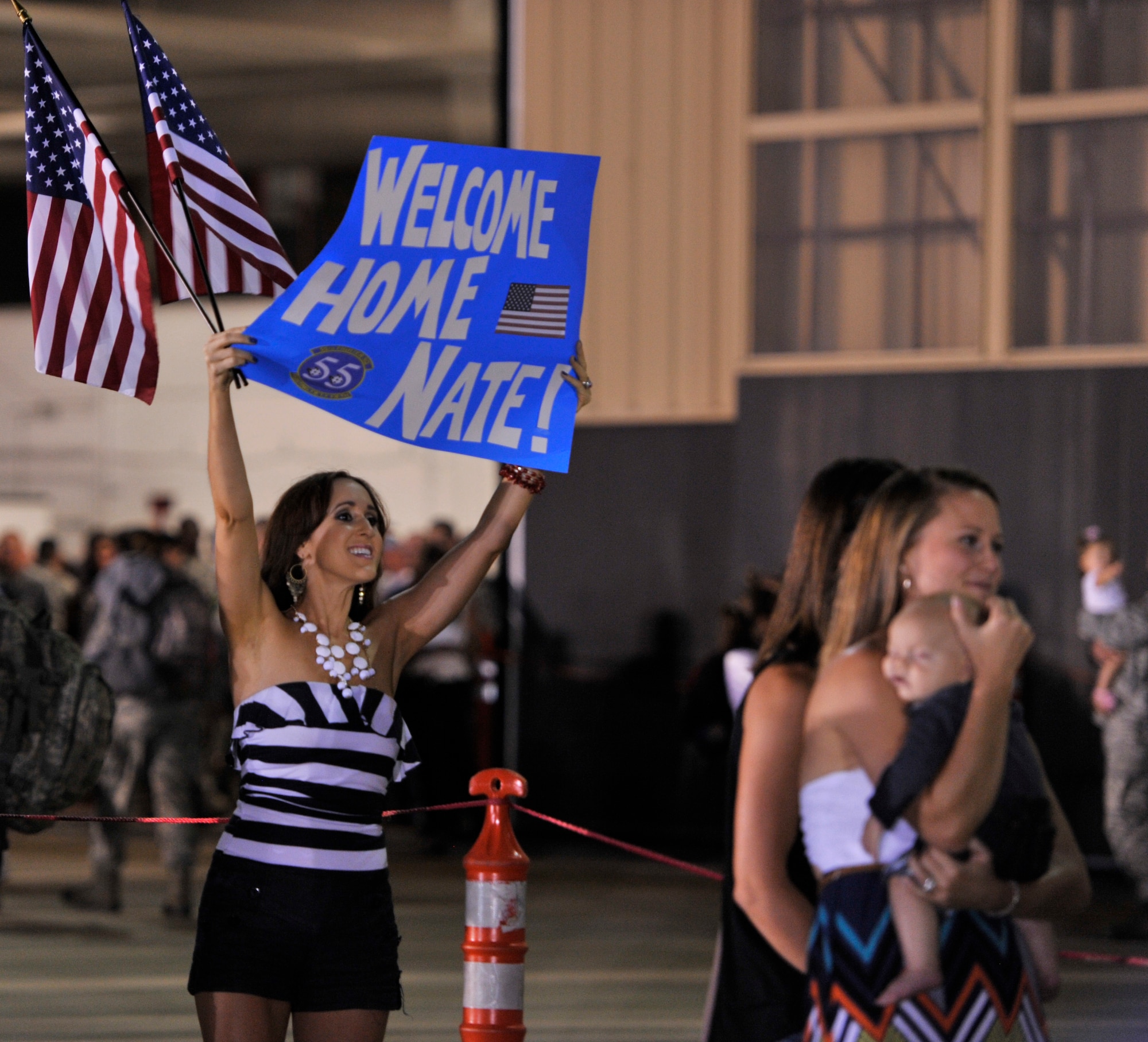 A family member waits for the return of her Airman, Shaw Air Force Base, S.C., Sept. 19, 2013. Airmen from the 20th Fighter Wing were deployed to Osan Air Base, Republic of Korea, for five months in an effort to bolster regional security in the region. (U.S. Air Force photo by Airman 1st Class Jonathan Bass/Released)