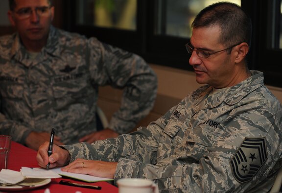 Chief Master Sgt. Dave Nordel, Twentieth Air Force command chief, takes notes during a breakfast meeting with chefs from the 91st Operations Group and 5th Forse Support Squadron at Minot Air Force Base, N.D., Sept. 16, 2013. The chefs voiced suggestions for improved training rotations between the 5th Bomb Wing and 91st Missile Wing as part of continued efforts by both to ensure their personnel are kept current on all necessary training. (U.S. Air Force photo/Senior Airman Stephanie Sauberan)