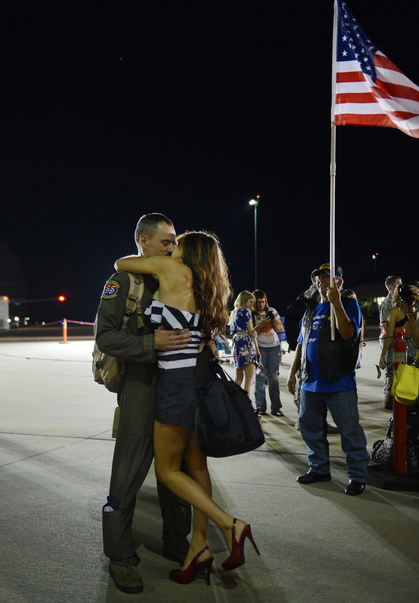 A U.S. Air Force Airman kisses his loved one after returning home, Shaw Air Force Base, S.C., Sept. 19, 2013. Airmen from the 20th Fighter Wing were deployed to Osan AB, Republic of Korea, for five months in an effort to bolster regional security in the region. (U.S. Air Force photo by Senior Airman Tabatha Zarrella/Released)