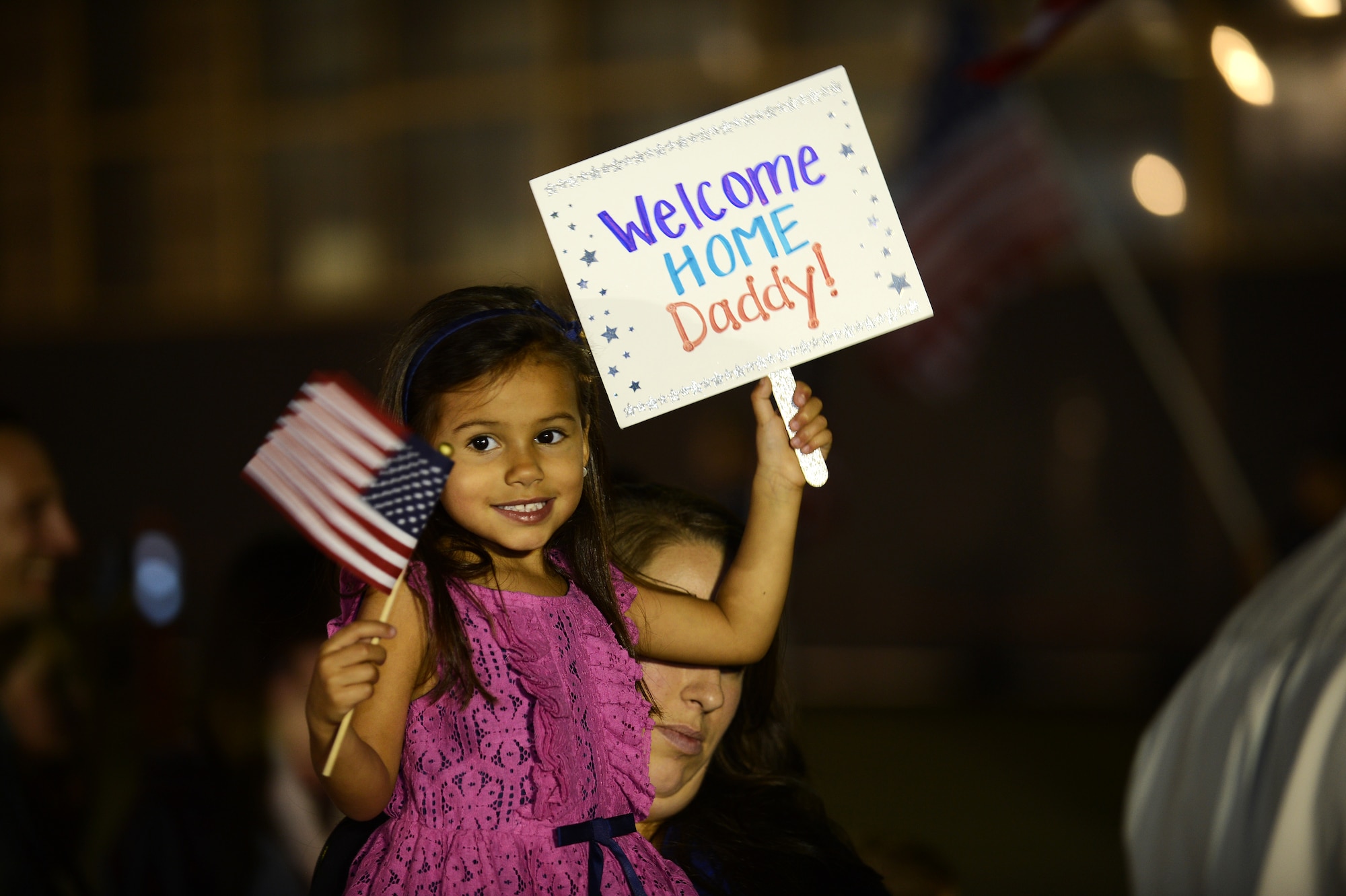 A young girl waits to welcome her father home from a deployment at Shaw Air Force Base, S.C., Sept. 19, 2013. Approximately 400 Airmen returned from a five-month deployment to Osan AB, Republic of Korea. (U.S. Air Force photo by Airman 1st Class Daniel Blackwell/Released)
