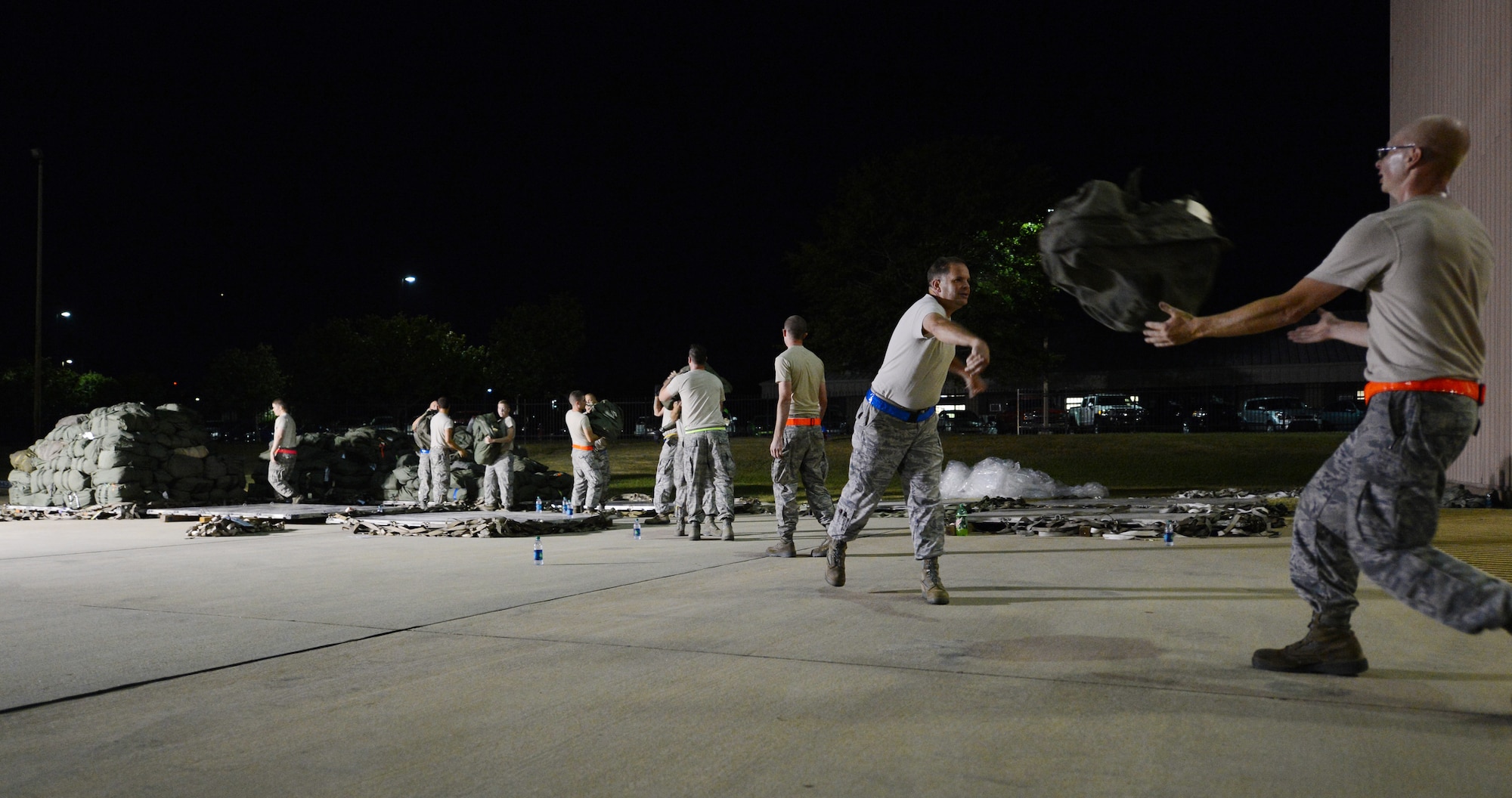 U.S. Air Force Airmen help  unload bags belonging to Airmen returning home, Shaw Air Force Base, S.C., Sept. 19, 2013. Airmen from the 20th Fighter Wing were deployed to Osan AB, Republic of Korea, for five months in an effort to bolster regional security in the region. (U.S. Air Force photo by Senior Airman Tabatha Zarrella/Released)