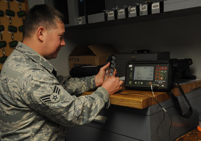 Senior Airman Eric Walker, 707th Maintenance Squadron non-destructive inspection journeyman, conducts an ultrasound thickness test on a piece of equipment on Barksdale Air Force Base, La., Sept. 19, 2013. By checking the thickness of a part, defects can be detected on the subsurface level. (U.S. Air Force photo/Senior Airman Benjamin Gonsier)