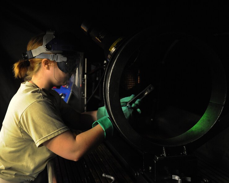 Senior Airman Sherry Phillips, 2nd Maintenance Squadron non-destructive inspection journeyman, conducts a fluorescent magnetic particle inspection on a piece of equipment on Barksdale Air Force Base, La., Sept. 19, 2013. A variety of parts come into NDI, from aircraft parts to standard vehicle components. The particles fill in any cracks, making it easier to determine if the part is serviceable. (U.S. Air Force photo/Senior Airman Benjamin Gonsier)