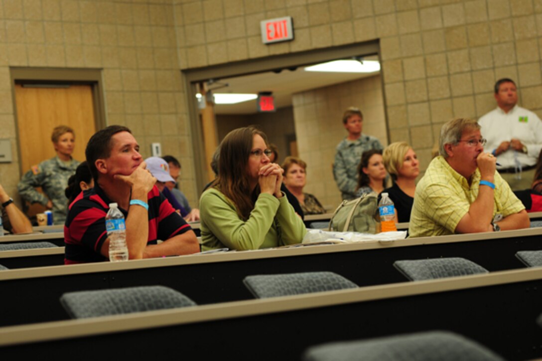 Community participants listen to a presentation during the South Dakota Coalition for Military Families providers symposium held at Camp Rapid, Rapid City, S.D., Sept. 12-13, 2013. The symposium brought together military and civilian care providers in a forum of support for all military members, veterans and their families. (Army National Guard photo by Staff Sgt. Michael Beck/RELEASED)