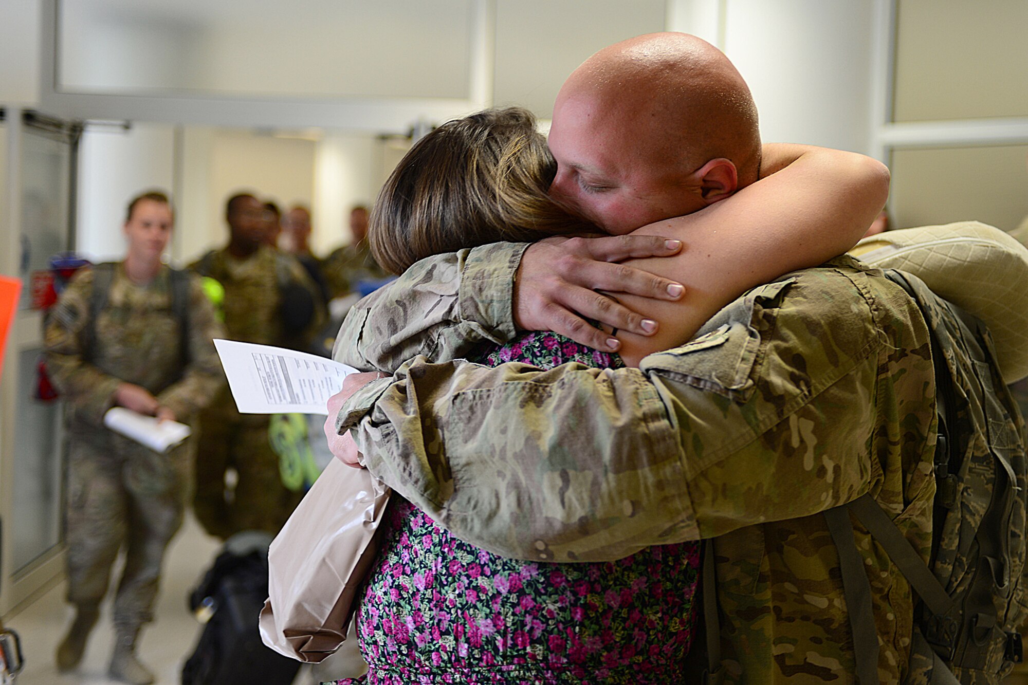 Senior Airman Mark Delaney, 748th Aircraft Maintenance Squadron, greets his wife Katie at Royal Air Force Mildenhall Sept. 19, 2013, following an almost four month deployment to Bagram Airfield, Afghanistan. Nearly 100 Airmen from the 56th Rescue Squadron and 748th AMXS, stationed at RAF Lakenheath, returned this week. (U.S. Air Force photo by Airman 1st Class Dana J. Butler/Released)