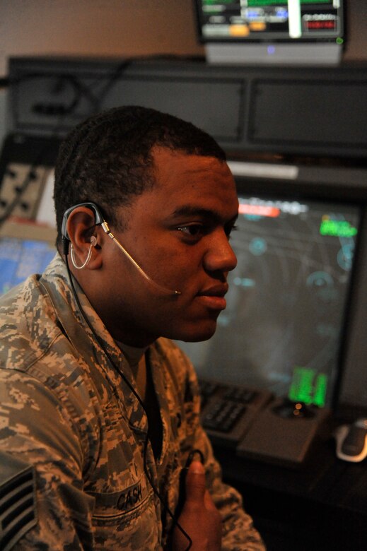 U.S. Air Force Staff Sgt. Kirk Cash, 509th Operation Support Squadron air traffic controller, simulates communication with local aircraft at Whiteman Air Force Base, Mo., Sept. 9, 2013. The simulator is used to train Airmen in scenarios involving air traffic volume and other emergencies. (U.S. Air Force photo by Airman 1st Class Keenan Berry/Released)