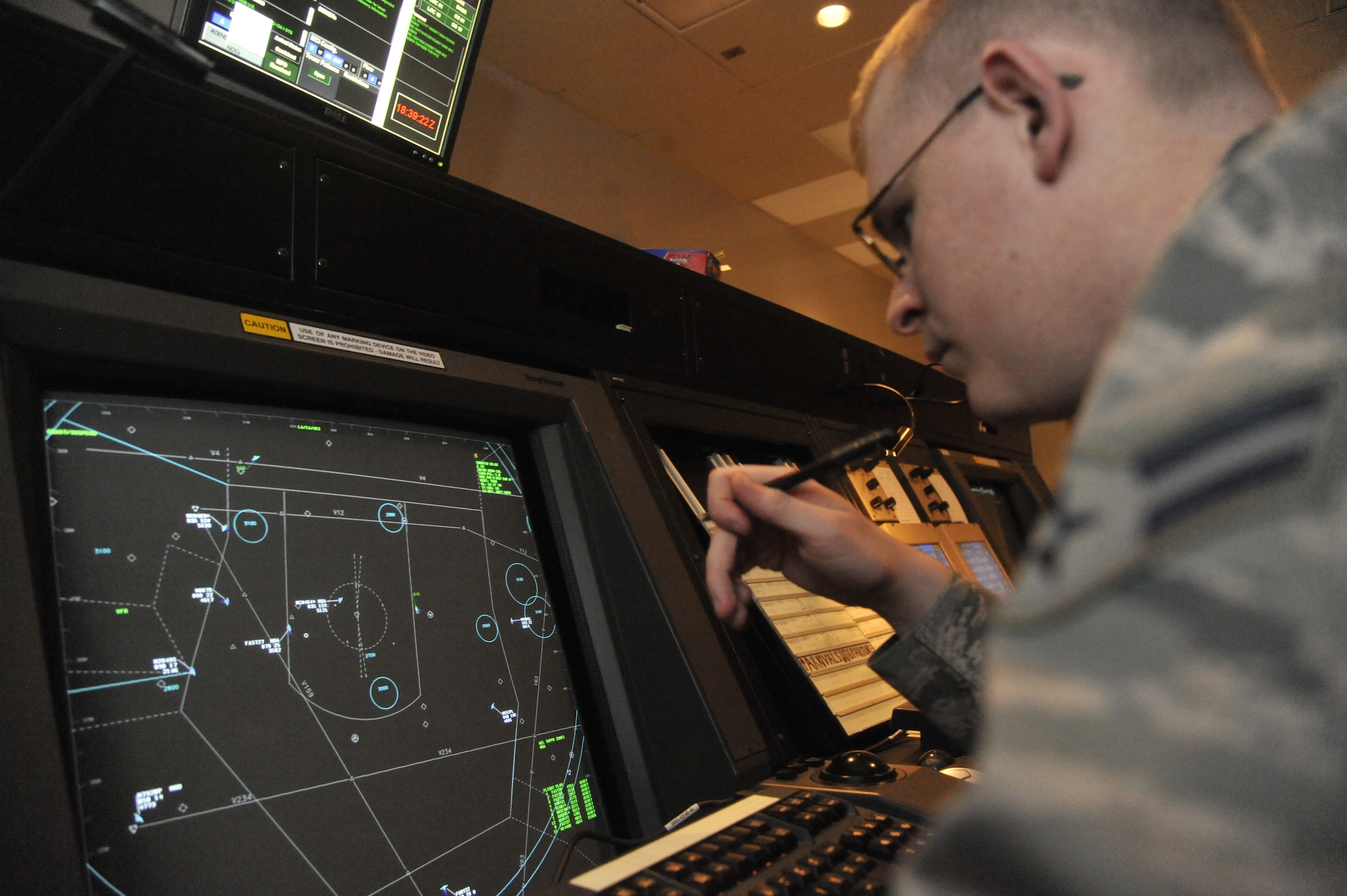 U.S. Air Force Airman 1st Class Derek Barb, 509th Operation Support Squadron air traffic control apprentice, operates the simulator at Whiteman Air Force Base, Mo., Sept. 9, 2013. The simulator is used to practice different situations and to prepare for real scenarios dealing with potential aircraft incidents. (U.S. Air Force photo by Airman 1st Class Keenan Berry/Released)