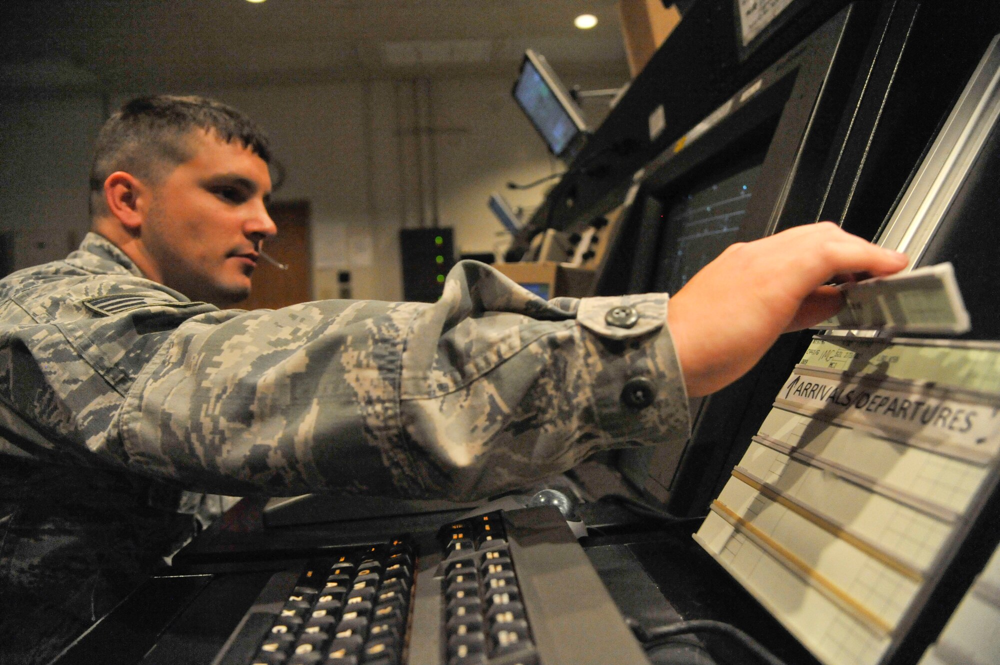 U.S. Air Force Staff Sgt. Samuel Baugh, 509th Operation Support Squadron air traffic control watch supervisor, places a flight strip into a strip bay, Whiteman Air Force Base, Mo., Sept. 9, 2013. Flight strips are used to keep track of aircraft missions, and contain the aircraft name, type, departure time, and instructions for landing. (U.S. Air Force photo by Airman 1st Class Keenan Berry/Released)