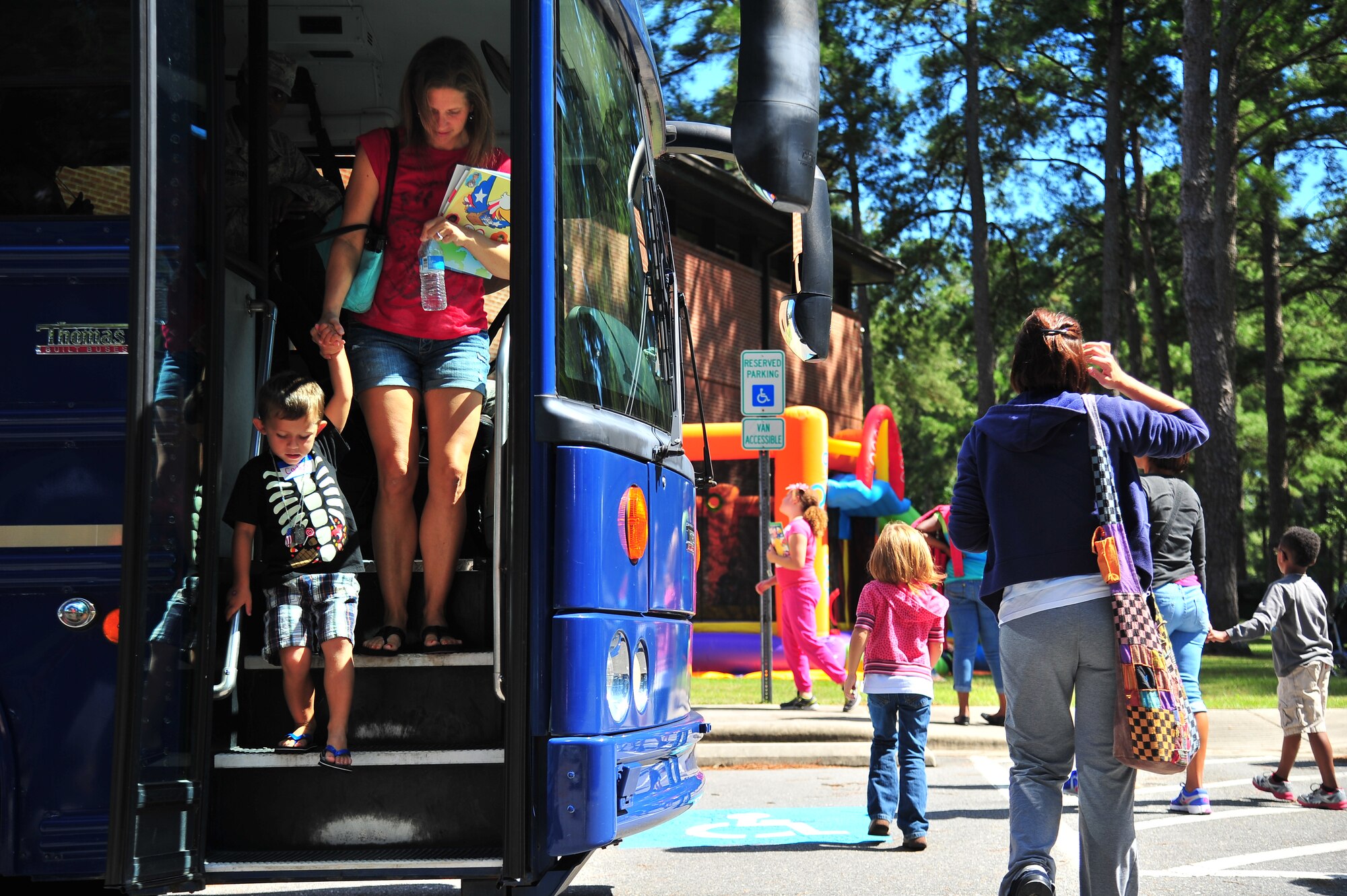 Team Seymour families arrive at their simulated deployed location during OPERATION BUG OUT, a mock deployment for children, at Seymour Johnson Air Force Base, N.C., Sept. 19, 2013. After receiving a threat awareness brief and processing through the Personnel Deployment Function, the families arrived at their area of operation to learn more about the deployment process. (U.S. Air Force photo by Senior Airman Aubrey White)