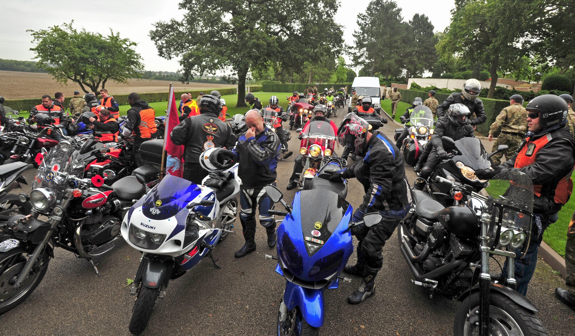 Participants of the joint RAF Mildenhall and RAF Lakenheath Rolling Thunder motorcycle rally prepare to tour and lay a wreath Sept. 19, 2013, at Madingley American Cemetery near Cambridge, England. Approximately 50 Airmen participated in the Prisoners of War/Missing in Action Rolling Thunder Remembrance Motorcycle Ride as part of the POW/MIA Remembrance week. Participants included both RAF and U.S. veteran and active duty members. (U.S. Air Force photo by Senior Airman Christine Griffiths/Released)