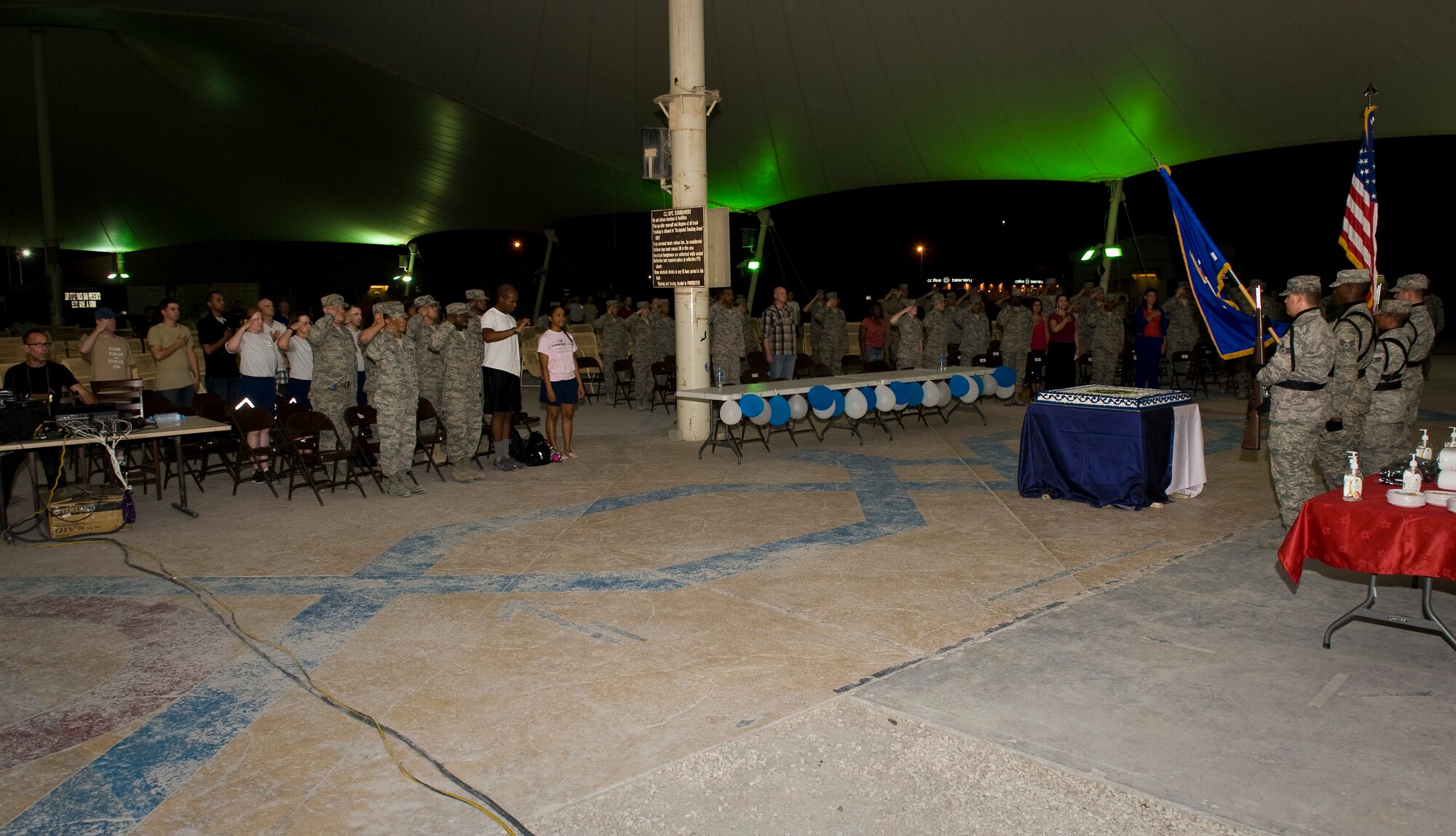 Service members deployed to the 379th Air Expeditionary Wing in Southwest Asia render salutes during the singing of the national anthem as part of the wing's Air Force birthday celebration Sept. 18, 2013. This year the Air Force celebrates 66 years of unparalleled service and air power. (U.S. Air Force photo/Staff Sgt. Benjamin W. Stratton)