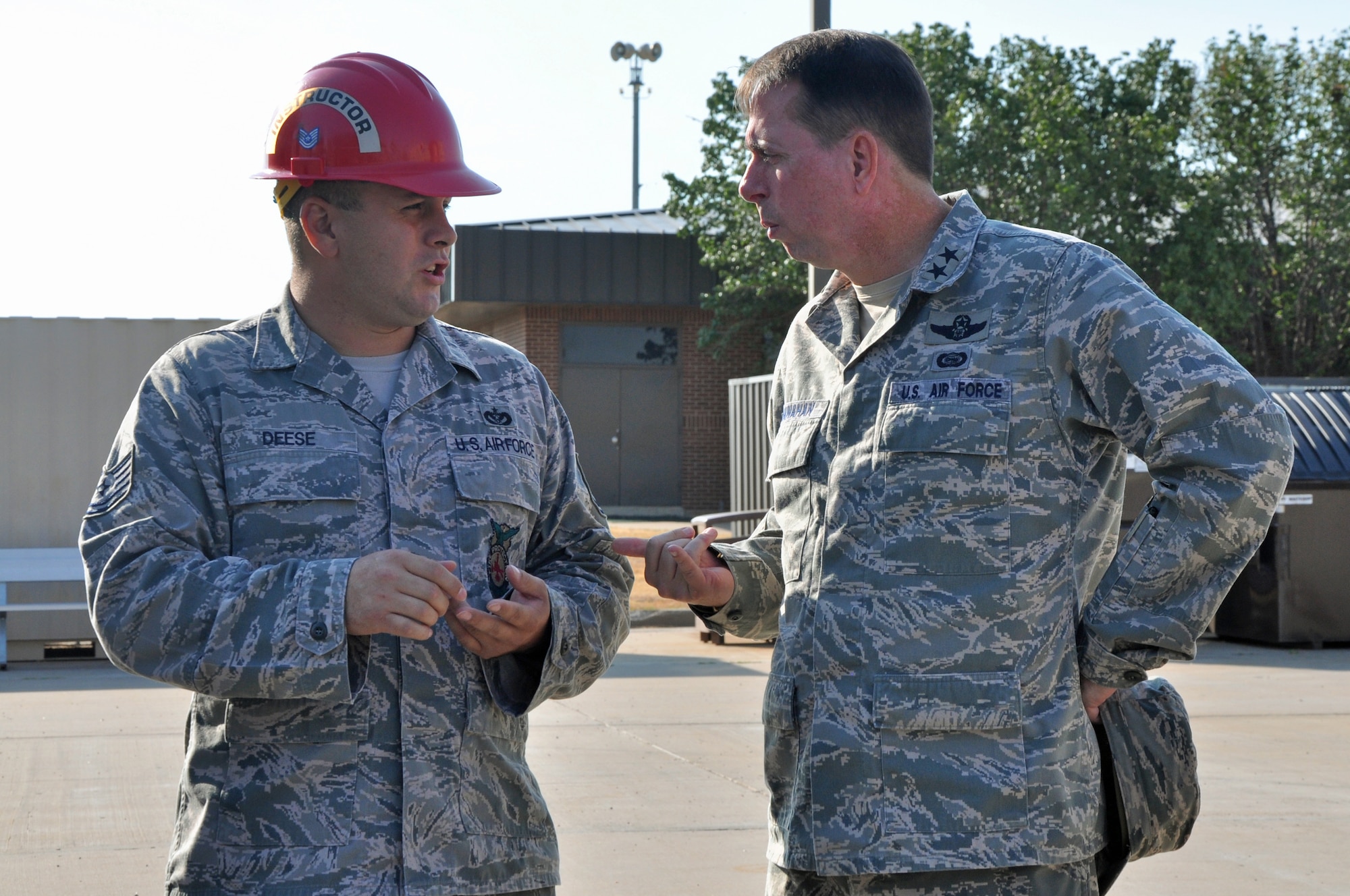 GOODFELLOW AIR FORCE BASE, Texas – Tech. Sgt. John Deese, 312th Training Squadron instructor, talks to Maj. Gen. John Shanahan, Air Force Intelligence, Surveillance and Reconnaissance Agency Commander, about the newest firefighter trainer at the Louis F. Garland Department of Defense Fire Academy, Sept. 13. The Fire Academy hosts roughly 15 advanced Fire Protection courses and a very intensive Fire Protection Apprentice Course. (U.S. Air Force photo/ Airman 1st Class Breonna Veal)