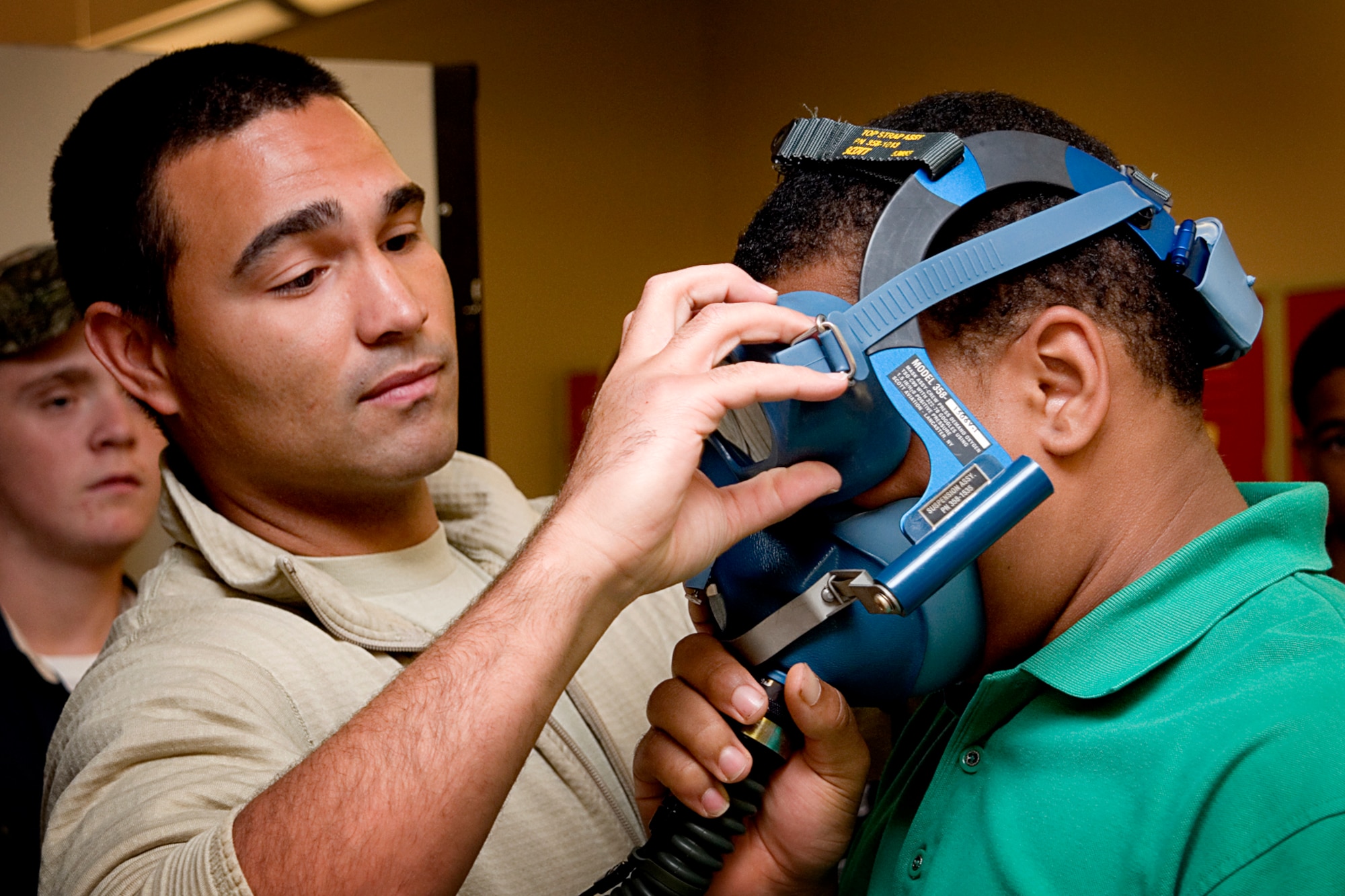 Staff Sgt. Lamar Woods, 434th Operations Support Squadron aircrew flight equipment specialist, demonstrates a mask fit test with a student from Anderson Prepatory Academy, Anderson, Ind., during a tour of Grissom Air Reserve Base, Ind., Aug. 14 2013. The students also saw a static display of a KC-135R Stratotanker during their visit. (U.S. Air Force photo/Tech. Sgt. Douglas Hays)