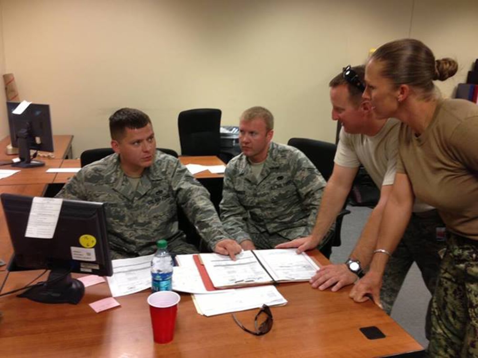 Tech. Sgt. Franco Reyes, 81st Aerialport Squadron and Senior Airman Bryan Parker, 38th APS and Staff Sgt. Patrick Bradley, 452nd Airlift Control Flight utilize ICODES to create a load plan with the Seabees Squad Leader EO1 Melanie Stokes,Naval Mobile Construction Battalion 17 for last month's Patriot Express exercise. (U.S. Air Force Reserve photo by Lt. Leanne Babcock) 
