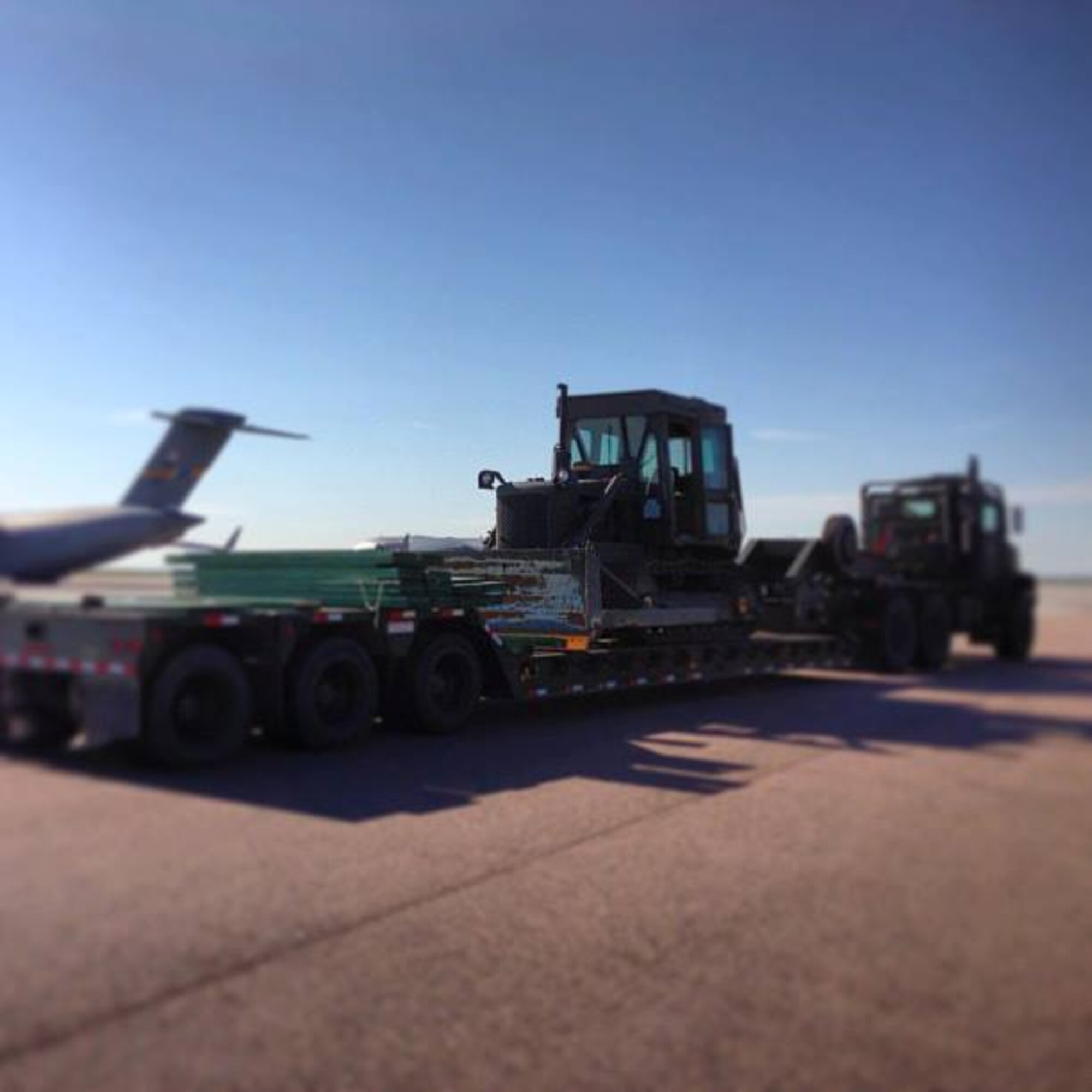 Maj. Scott Hazzard and Staff Sg.t Gary Lamb from the 315th Airlift Control Flight and Staff Sgt. Allyson Williams, 512th ALCF from Dover, assist in preparing a generator for load. The ALCFs embrace the enabler concept, all Airmen help move the mission. (U. S. Air Force Reserve photo by 1st Lt. Leanne Babcock) 