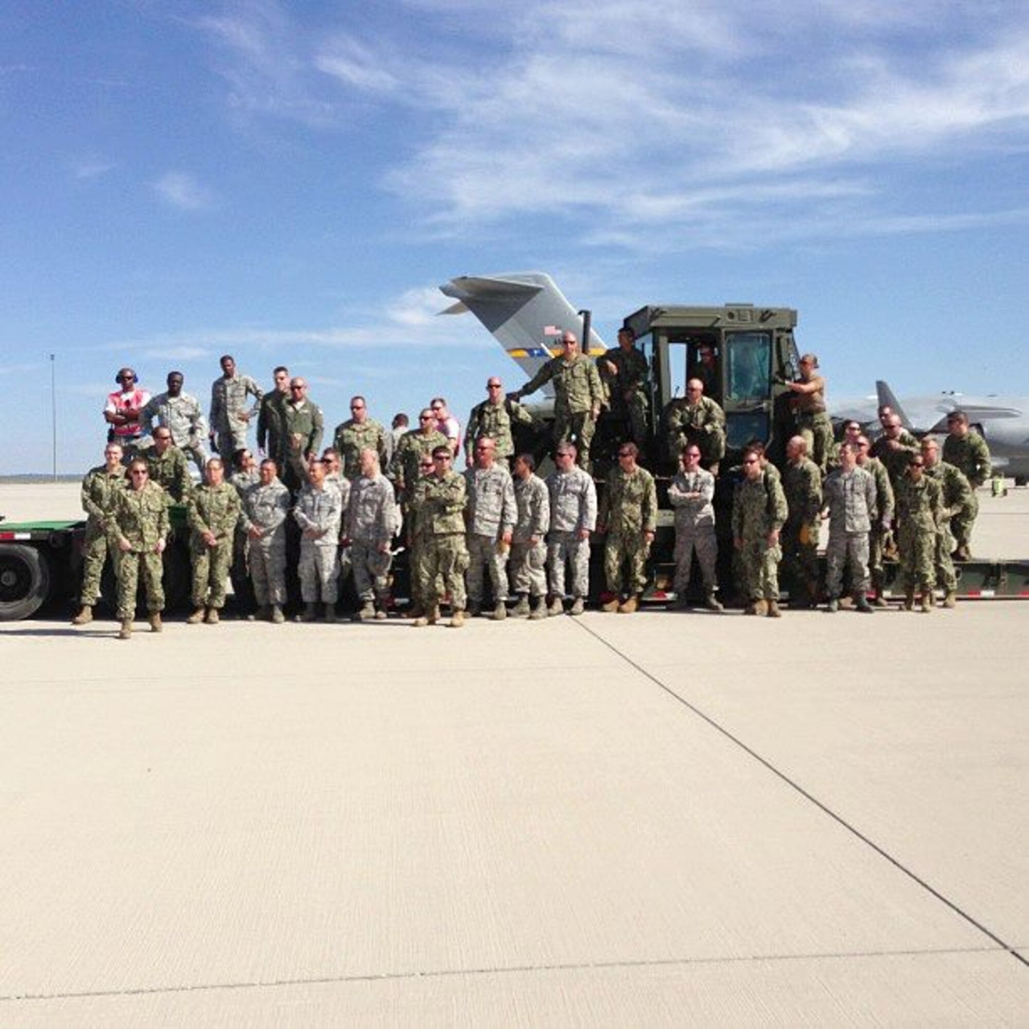 Pre-Static load of a Seabee bulldozer.  Pictured are the Airmen and Sailors from 315th Airlift Control Flight, 38th Aerialport Squadron, 18st APS and Naval Mobile Construction Battalion 17 during last month's Patriot Express exercise in Colorado. (U.S. Air Force Reserve Photo by 1st Lt. Leanne Babcock)