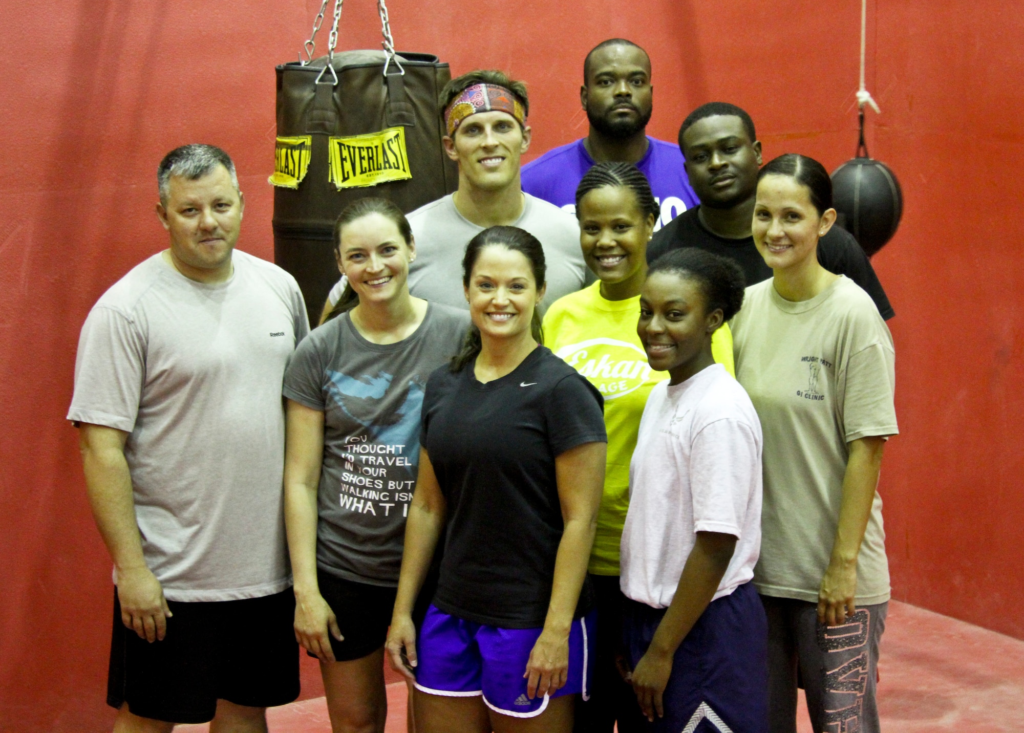 Airmen from the 64th Air Expeditionary Group pose for a group photo during a women's self-defense class in Southwest Asia, July 30, 2013. The class was developed to give women techniques to defend themselves from attacking assailants. (Courtesy photo)