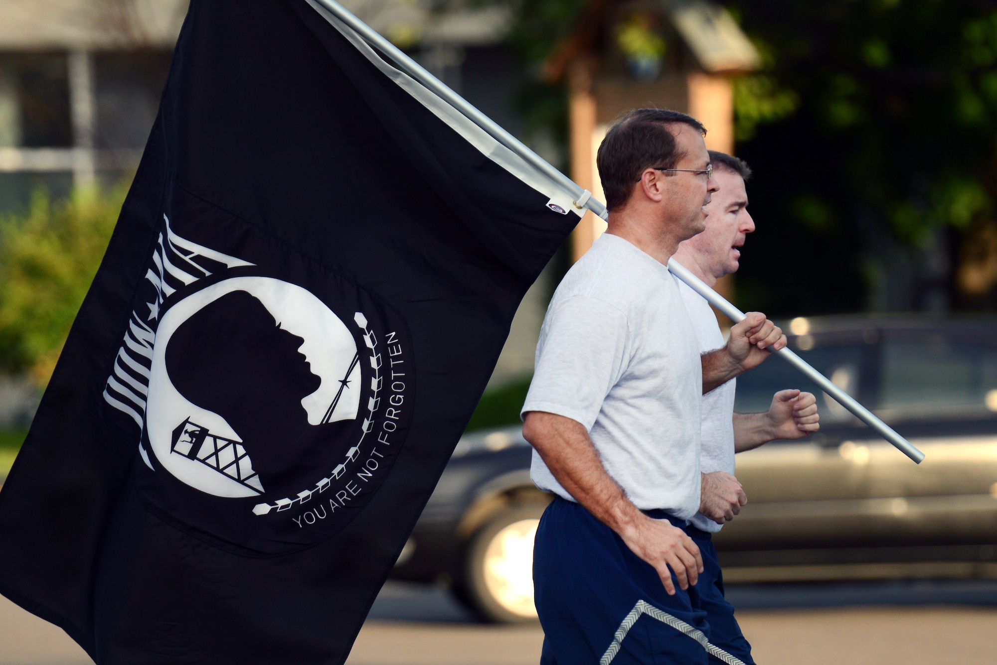 U.S. Air Force Col. Stephen Williams, 35th Fighter Wing commander, front, and Chief Master Sgt. Gary Sharp, 35 FW command chief, begin the first leg of a remembrance run at Misawa Air Base, Japan, Sept. 19, 2013. To honor all of the prisoners of war and those missing in action, the 35 FW ran 24 hours straight for the POW/MIA Remembrance Day. (U.S. Air Force photo by Airman 1st Class Zachary Kee)