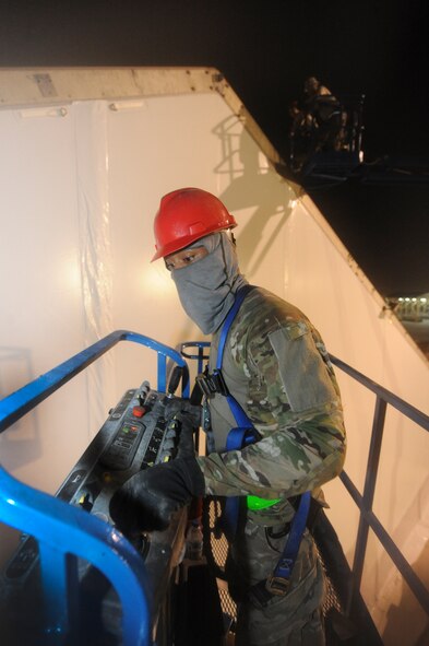 U.S. Air Force Staff Sgt. David Coplin, 577th Expeditionary PRIME BEEF Squadron, navigates a lift during a hangar renovation at an undisclosed location in Southwest Asia August 29, 2013. Airmen from the 577th EPBS replaced insulation and changed out the outer layer of the hangar during the renovation. Coplin is native to Winston-Salem, N.C., and is deployed from Seymour Johnson Air Force Base, N.C. (U.S. Air Force photo by Staff Sgt. Joshua J. Garcia)