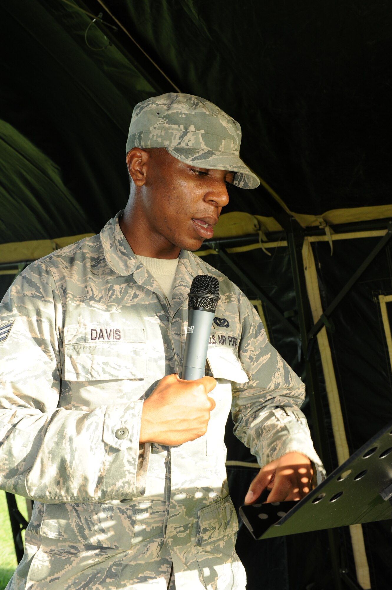 U.S. Air Force Senior Airman Brandon Davis, 18th Civil Engineer Squadron heavy equipment operator journeyman, reads aloud the names of the prisoners of war and missing in action personnel at the POW/MIA 24-hour vigil run on Kadena Air Base, Japan, Sept. 19, 2013. This is an annual event to honor more than 70,000 POW and MIA personnel. (U.S. Air Force photo by Airman 1st Class Hailey R. Davis)