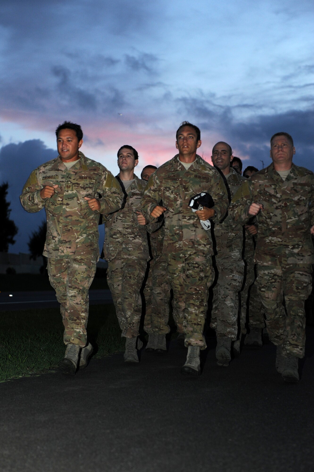 Personnel from the 320th Special Tactics Squadron run with the POW/MIA flag at a 24-hour vigil run on Kadena Air Base, Japan, Sept. 20, 2013. National POW/MIA Remembrance Day is observed on the third Friday of September every year, but it is important to always remember the sacrifice of POW and MIA personnel. (U.S. Air Force photo by Airman 1st Class Hailey R. Davis)