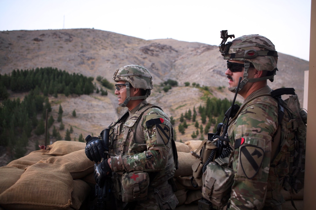 U.S. Army Staff Sgt. Erik Nieto, left, and U.S. Army Sgt. Christopher Alderman observe the scenery on a sub-level roof of the U.S. Consulate in Herat city in Herat province, Afghanistan, Sept. 14, 2013. Nieto and Alderman are assigned to the 1st Cavalry Division's Company D, 1st Battalion, 5th Cavalry Regiment, 2nd Brigade Combat Team.
