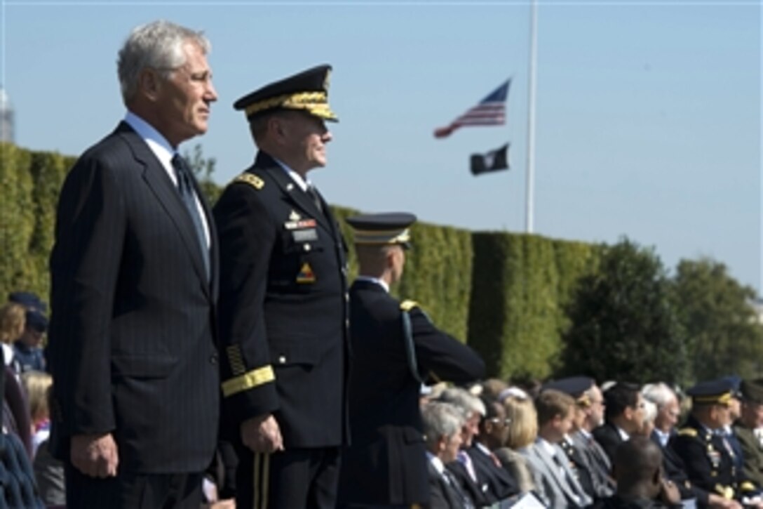 Secretary of Defense Chuck Hagel and Chairman of the Joint Chiefs of Staff Gen. Martin Dempsey stand for the march in review during the Department of Defense National POW/MIA Recognition Day ceremony at the Pentagon in Arlington, Va., on Sept. 20, 2013.  The ceremony pays tribute to those service members who have not returned from the battlefield and those who are held captive as prisoners of war.  