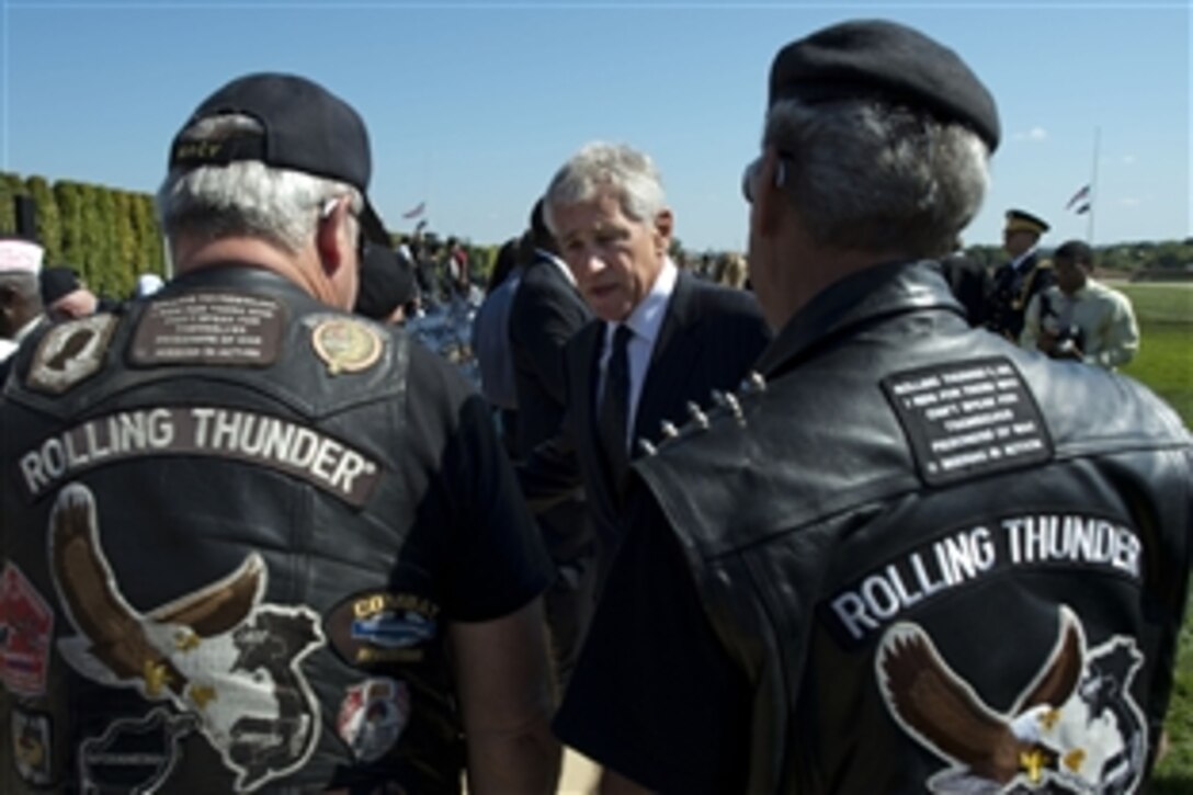 Defense Secretary Chuck Hagel greets Rolling Thunder motorcyclists following a ceremony to remember prisoners of war and service members missing in action at the Pentagon, Sept. 20, 2013.