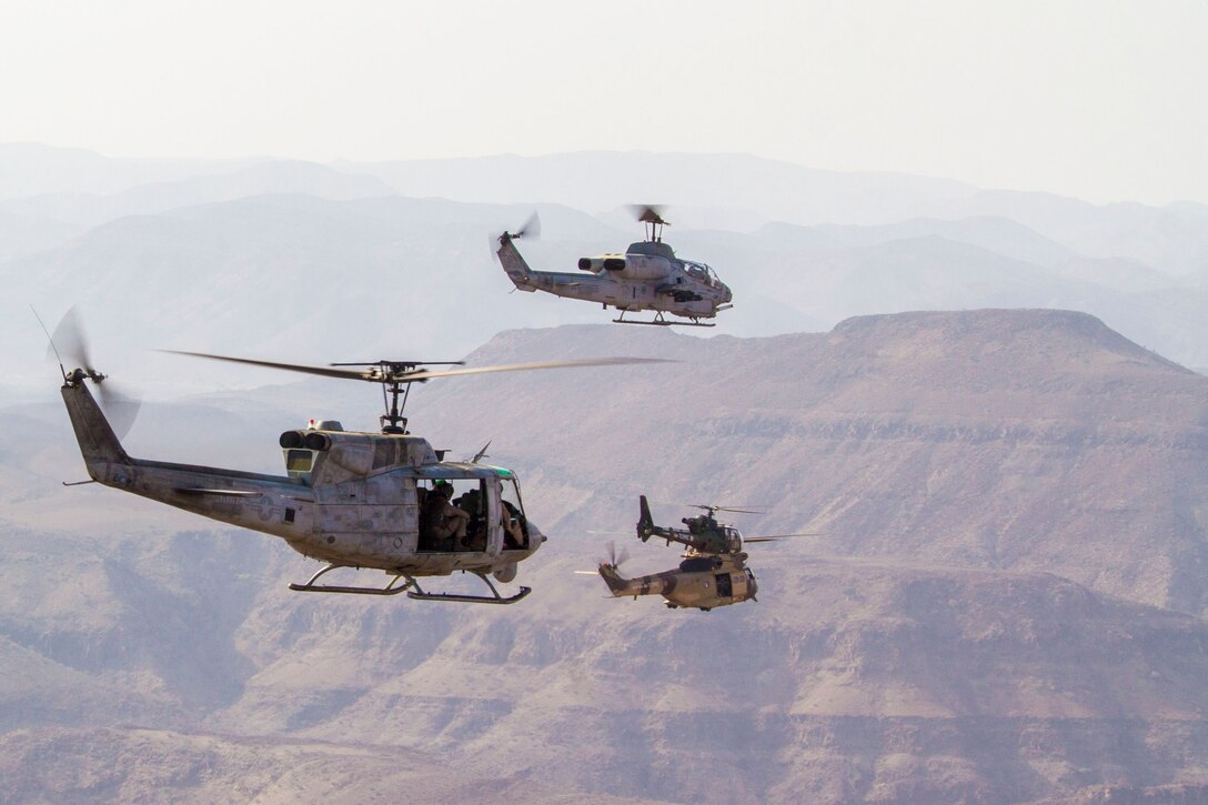 U.S Marine Corps helicopters assigned to Marine Medium Tiltrotor Squadron (VMM) 266 (Reinforced), 26th Marine Expeditionary Unit (MEU), and French Army helicopters fly in formation above Camp Lemonnier, Djibouti, Sept. 18, 2013. The 26th MEU is a Marine Air-Ground Task Force forward-deployed to the U.S. 5th and 6th Fleet areas of responsibility aboard the Kearsarge Amphibious Ready Group serving as a sea-based, expeditionary crisis response force capable of conducting amphibious operations across the full range of military operations. (U.S. Marine Corps photo by Cpl. Kyle N. Runnels/Released)