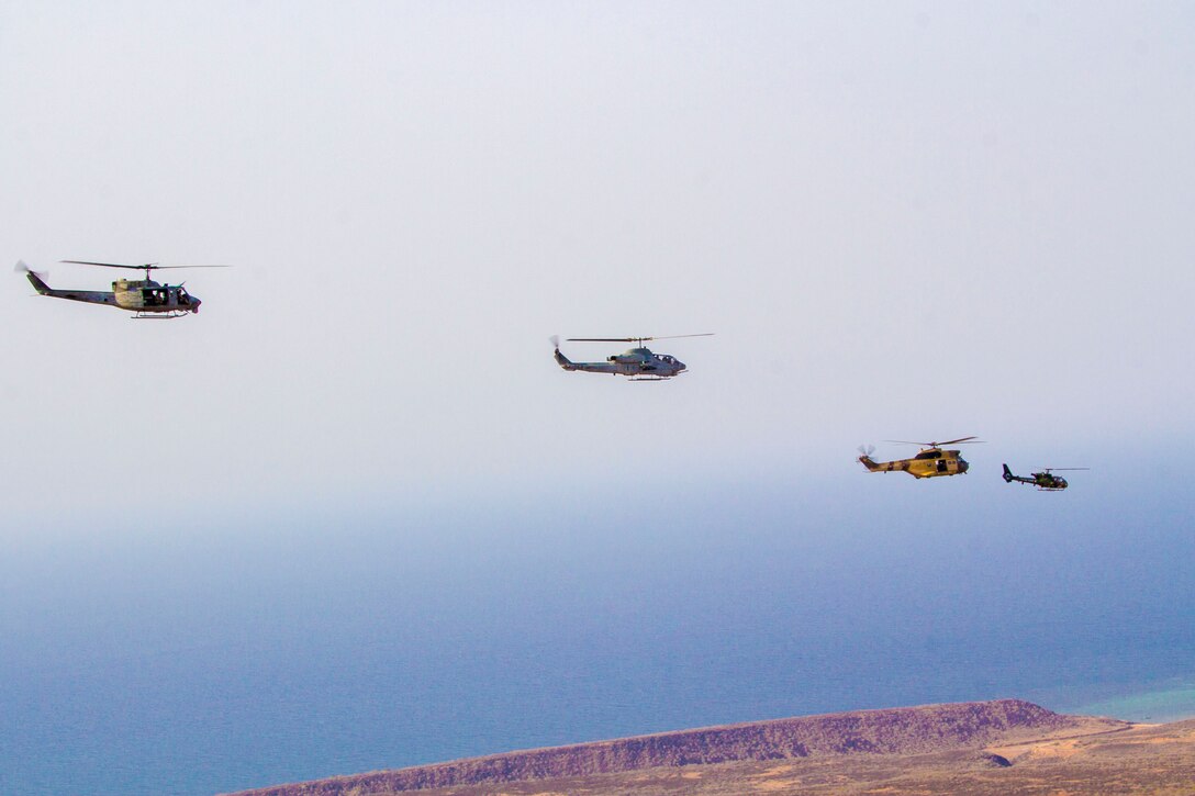 U.S Marine Corps helicopters assigned to Marine Medium Tiltrotor Squadron (VMM) 266 (Reinforced), 26th Marine Expeditionary Unit (MEU), and French Army helicopters fly in formation above Camp Lemonnier, Djibouti, Sept. 18, 2013. The 26th MEU is a Marine Air-Ground Task Force forward-deployed to the U.S. 5th and 6th Fleet areas of responsibility aboard the Kearsarge Amphibious Ready Group serving as a sea-based, expeditionary crisis response force capable of conducting amphibious operations across the full range of military operations. (U.S. Marine Corps photo by Cpl. Kyle N. Runnels/Released)