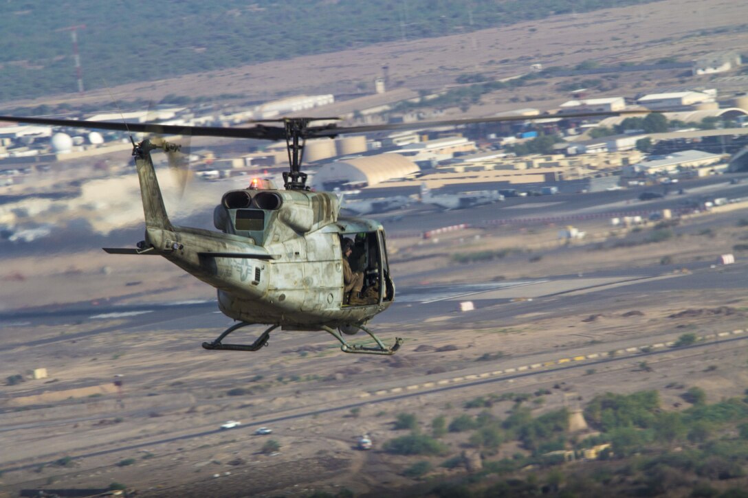 A UH-1N Huey assigned to Marine Medium Tiltrotor Squadron (VMM) 266 (Reinforced), 26th Marine Expeditionary Unit (MEU), flies above Camp Lemonnier, Djibouti, Sept. 18, 2013. The 26th MEU is a Marine Air-Ground Task Force forward-deployed to the U.S. 5th and 6th Fleet areas of responsibility aboard the Kearsarge Amphibious Ready Group serving as a sea-based, expeditionary crisis response force capable of conducting amphibious operations across the full range of military operations. (U.S. Marine Corps photo by Cpl. Kyle N. Runnels/Released)