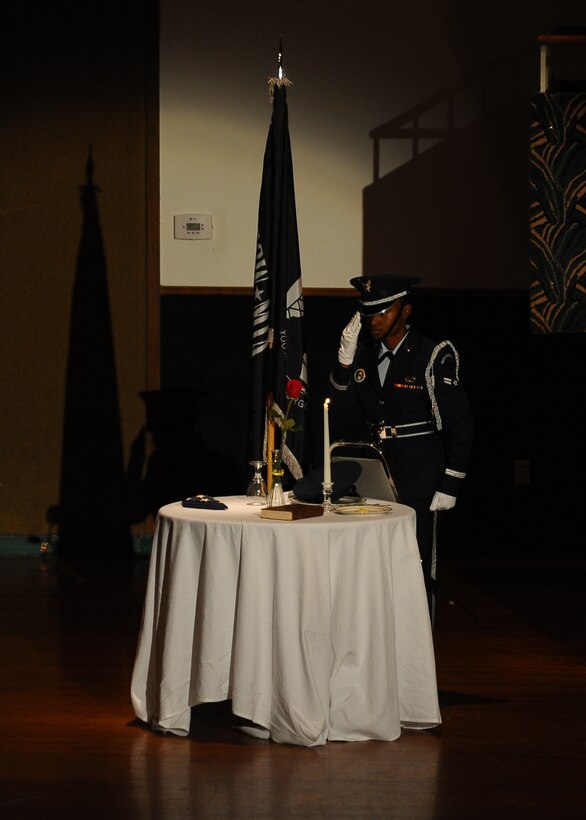 Airman 1st Class Julianna White, 14th Comptroller Squadron, performs the POW/MIA Missing Man ceremony during the 2013 Air Force Birthday Ball. The ceremony honors those who may have been taken prisoner or have gone missing during wartimes. (U.S. Air Force Photo/Airman 1st Class Stephanie Englar)