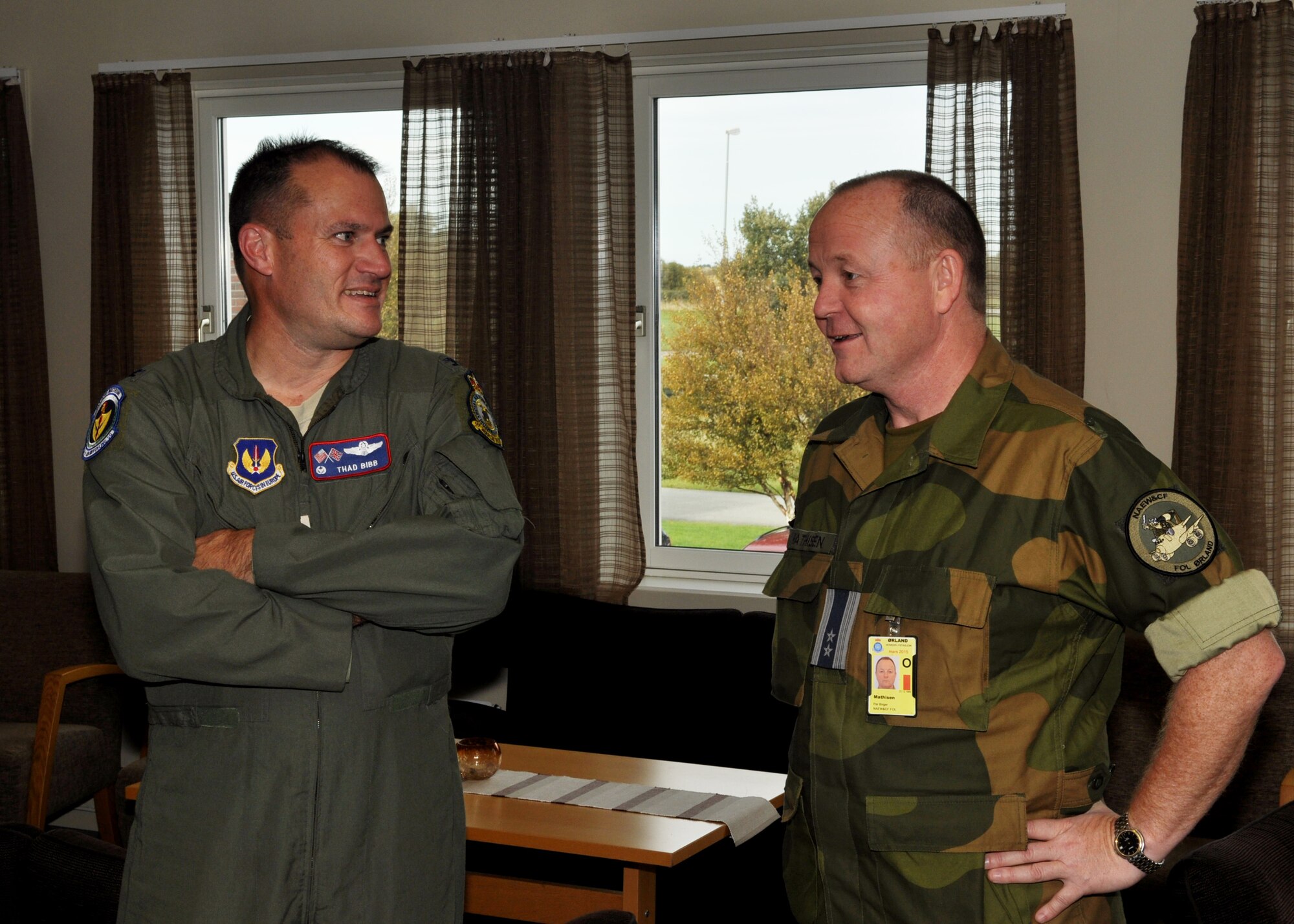 U.S. Air Force Col. Kenneth T. Bibb Jr., left, 100th Air Refueling Wing commander, and Norwegian air force Lt. Col. Per Mathisen, Ørland Main Air Station, Norway, and NATO Forward Operations commander, talk about the success their people and aircraft have had so far in the Arctic Challenge exercise Sept. 19, 2013, on Ørland MAS. Mathisen commands facilities which support various NATO aircraft. (U.S. Air Force photo by 1st Lt. Christopher Mesnard/Released)