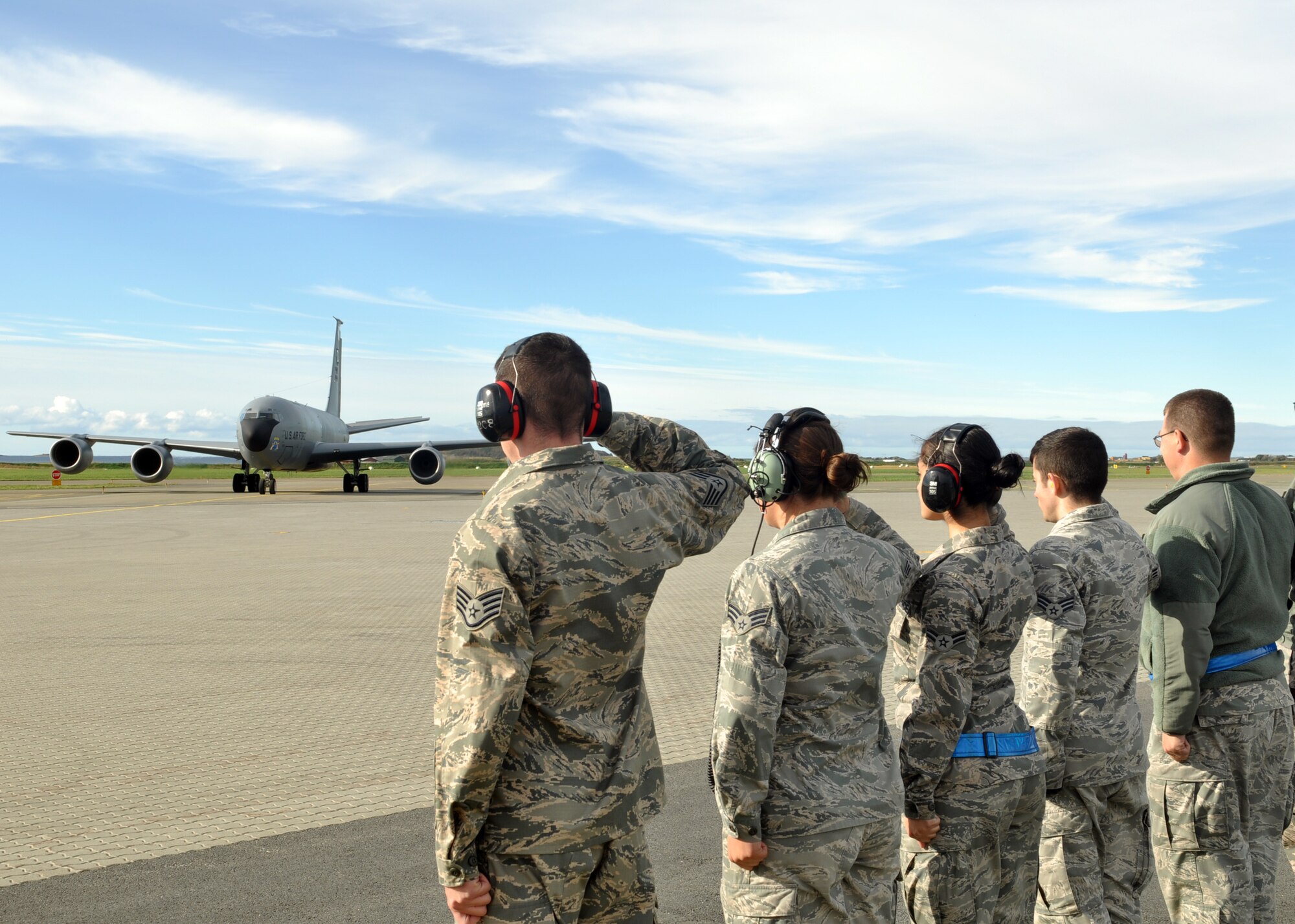 Airmen from the 100th Air Refueling Wing salute the aircraft carrying Col. Kenneth T. Bibb Jr., 100th ARW commander, Sept. 19, 2013, after the aircraft landed at Ørland Main Air Station, Norway. Bibb visited to speak with members of the "Bloody Hundredth" participating in the Arctic Challenge exercise and to extend his gratitude to the local Norwegian air force for its hospitality. (U.S. Air Force photo by 1st Lt. Christopher Mesnard/Released)