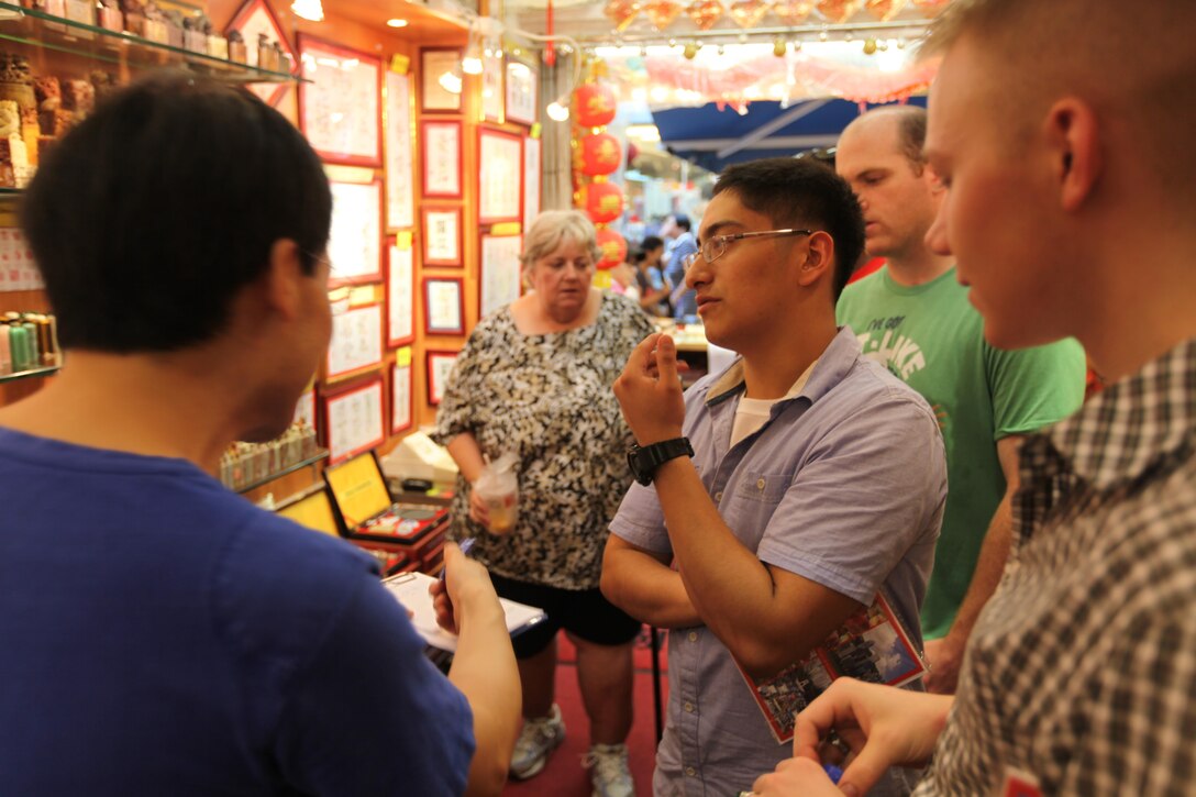 Marines of the 31st Marine Expeditionary Unit and Sailors of the USS Bonhomme Richard (LHD 6) peruse traditional Chinese art with their host at the Stanley Market here, Sept 20. The service members were participating in the Meals in the Home program while on liberty. The program, sponsored by the American Women’s Association of Hong Kong, aims to provide a home-like environment for Marines and Sailors from ships entering Hong Kong. The liberty port was a scheduled stop on the 31st MEU’s regularly scheduled Fall Patrol. The 31st MEU is the Marine Corps’ force in readiness in the Asia-Pacific region and the only continuously forward-deployed MEU. 