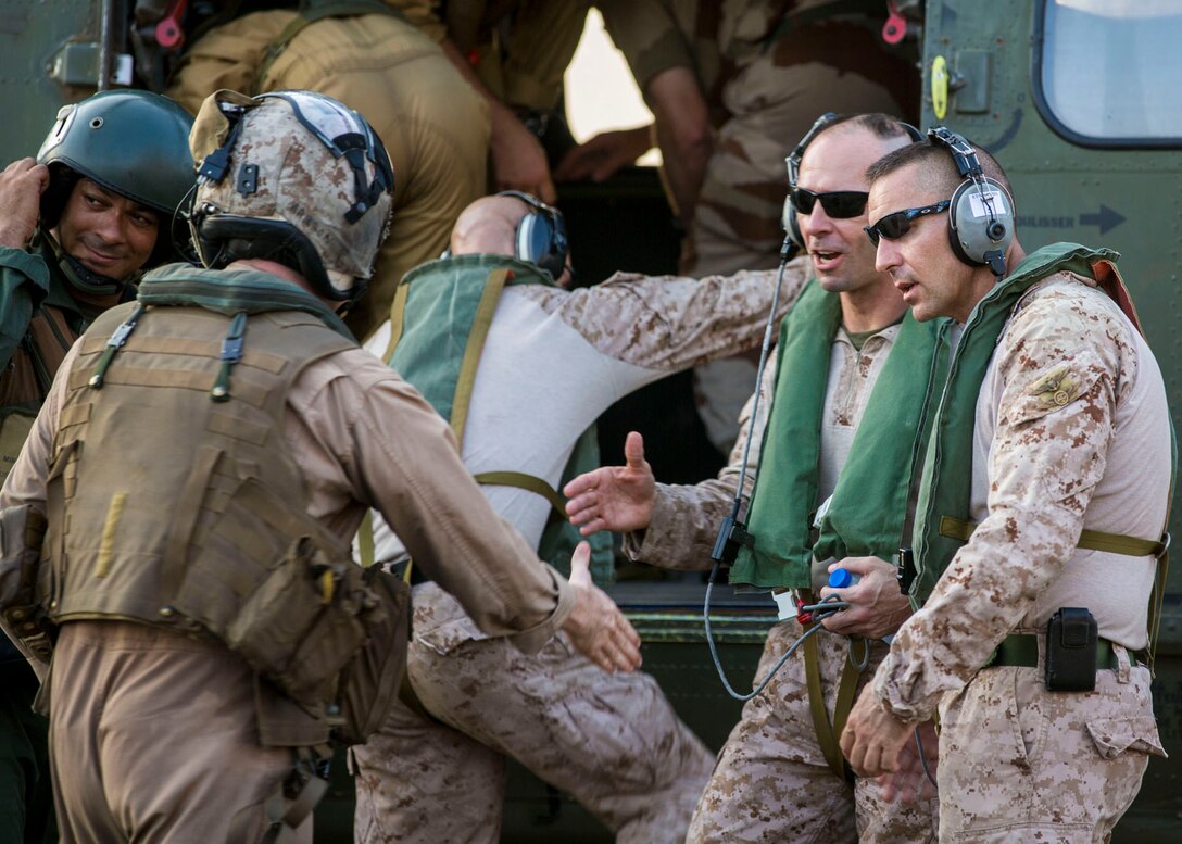 26th Marine Expeditionary Unit (MEU) senior leaders greet crewmembers of a French SA 330 Puma helicopter on the flight deck of the USS Kearsarge (LHD 3), Sept. 22, 2013. The 26th MEU is a Marine Air-Ground Task Force forward-deployed to the U.S. 5th and 6th Fleet areas of responsibility aboard the Kearsarge Amphibious Ready Group serving as a sea-based, expeditionary crisis response force capable of conducting amphibious operations across the full range of military operations. (U.S. Marine Corps photo by Sgt. Christopher Q. Stone, 26th MEU Combat Camera/Released)