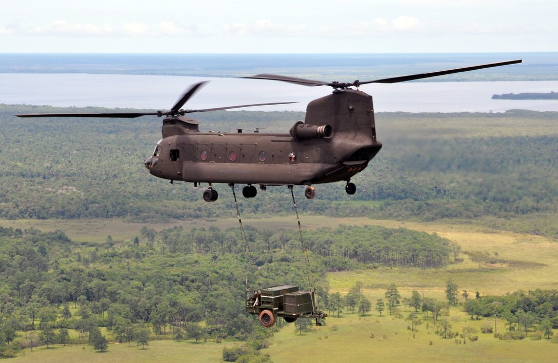 A CH-47 Chinook helicopter assigned to Joint Task Force-Bravo makes its return flight from Puerto Lempira, Honduras, to Soto Cano Air Base while carrying a sling-loaded environmental control unit weighing more than 4,800 pounds, Sept. 21, 2013. The environmental control unit was used to support JTF-Bravo's mobile surgical team while they provided medical assistance in the Gracias a Dios region of Honduras. (U.S. Air Force photo by Capt. Zach Anderson)