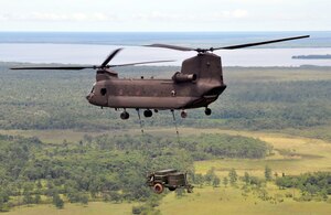 A CH-47 Chinook helicopter assigned to Joint Task Force-Bravo makes its return flight from Puerto Lempira, Honduras, to Soto Cano Air Base while carrying a sling-loaded environmental control unit weighing more than 4,800 pounds, Sept. 21, 2013. The environmental control unit was used to support JTF-Bravo's mobile surgical team while they provided medical assistance in the Gracias a Dios region of Honduras. (U.S. Air Force photo by Capt. Zach Anderson)
