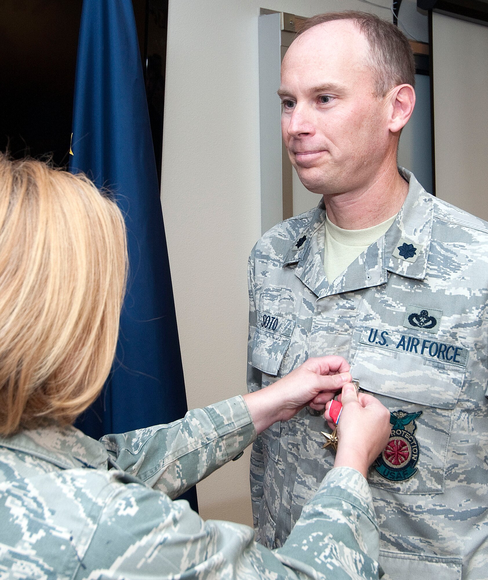 JOINT BASE ELMENDORF-RICHARDSON, Alaska -- Lt. Col. Ed Soto, commander of the 176 Civil Engineer Squadron, receives the Bronze Star Medal from Col. Patty Wilbanks, commander of the 176 Mission Support Group, in a ceremony here Sept. 22, 2013. Soto earned the award, one of America's highest military decorations, for exceptionally distinguished performance while deployed to Kandahar Airfield, Afghanistan, from February 2012 to August 2012. National Guard photo by Capt. John Callahan/Released.