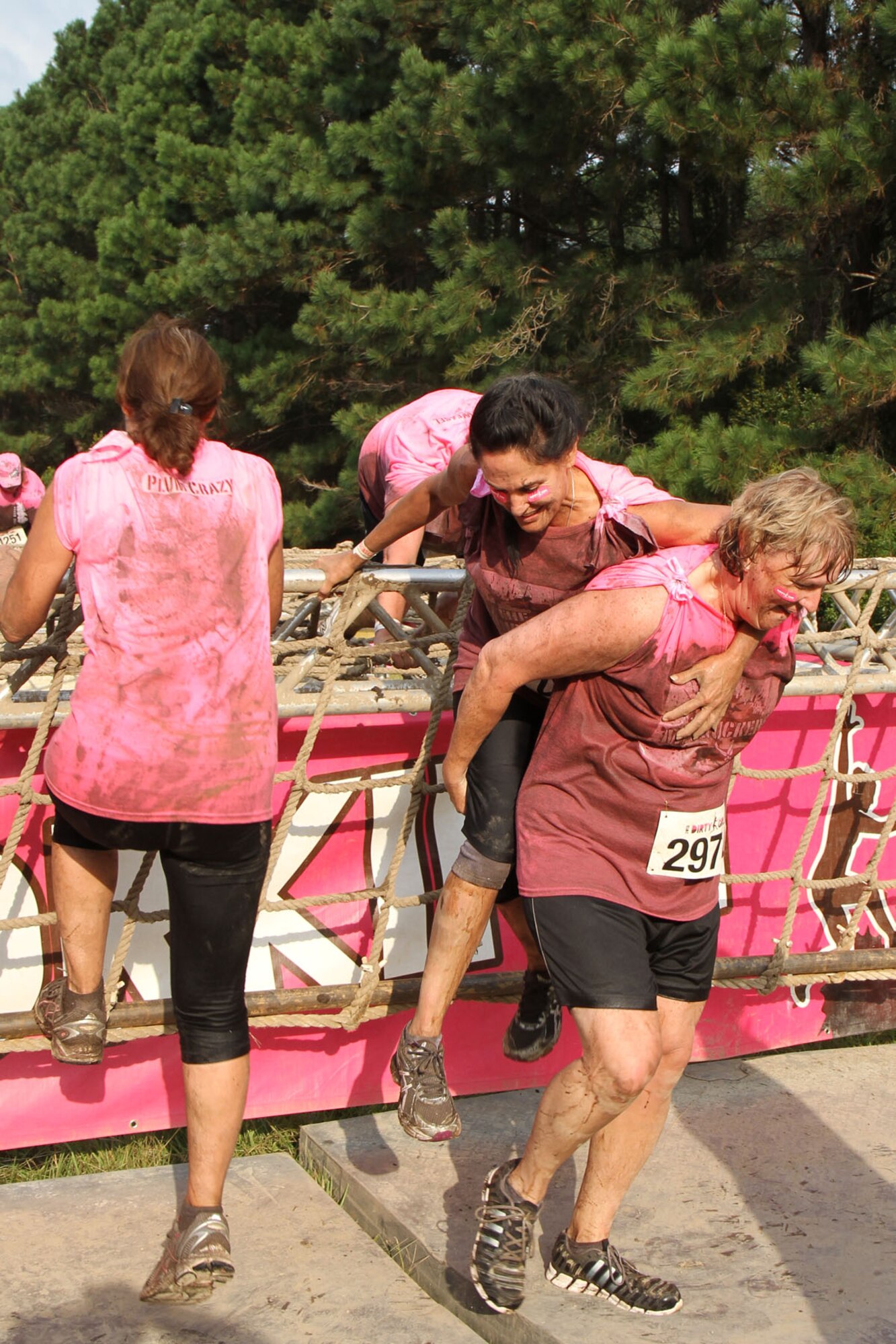 The “Mudruckers,” a team of 315th Airlift Wing Reservists and their friends, celebrate the completion of the Dirty Girl Mud Run Saturday Sept. 14, 2013, by taking a dip in the final mud pit at Legare Farms on Johns Island, S.C. The women’s-only 5K run helps raise money for breast and ovarian cancer research while also increasing awareness of the warning signs and symptoms of these diseases.