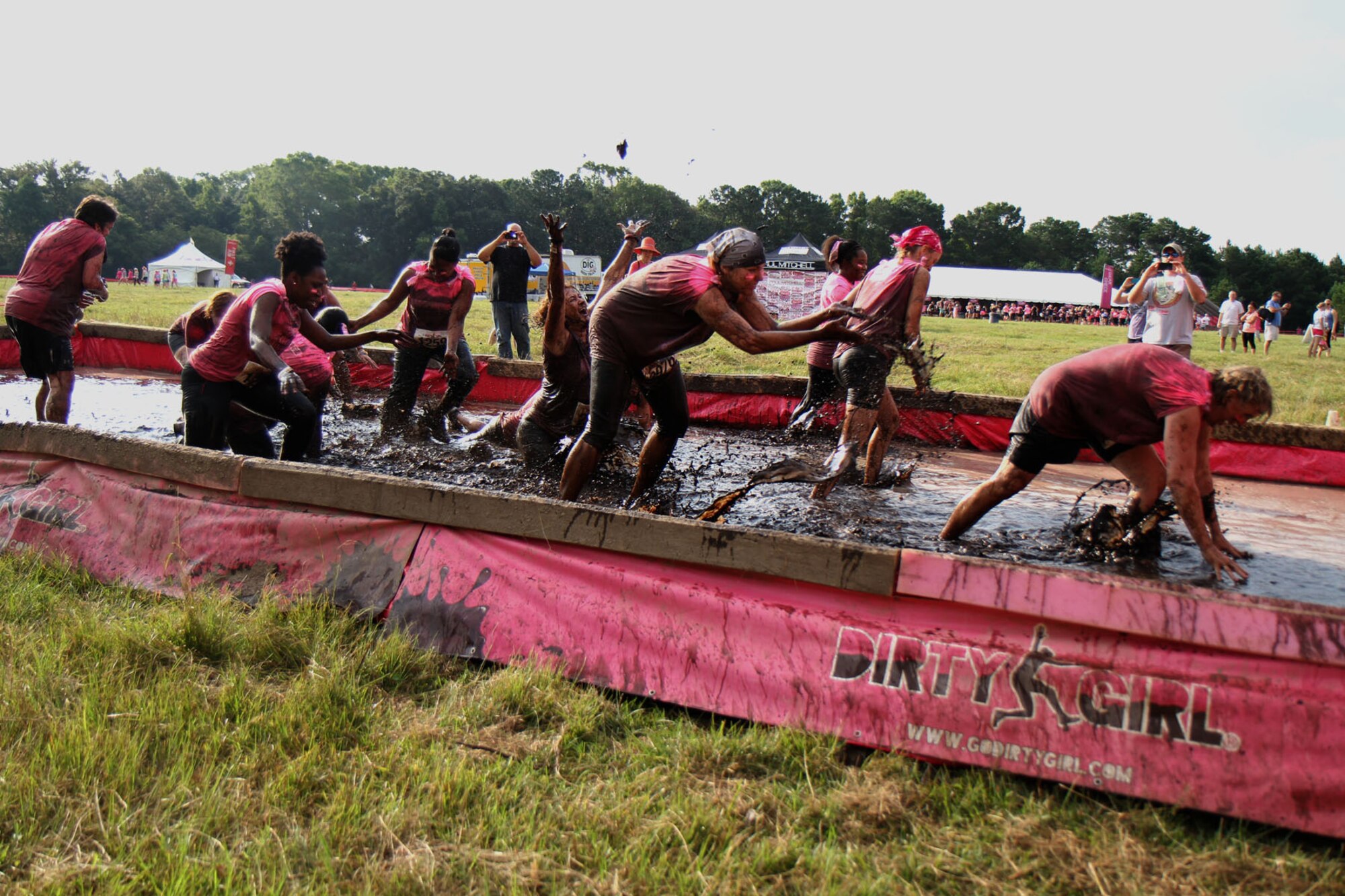 The “Mudruckers,” a team of 315th Airlift Wing Reservists and their friends, link arms as they near the final mud pit obstacle of the Dirty Girl Mud Run held at Legare Farms on Johns Island, S.C. Sept. 14, 2013. The women’s-only 5K run helps raise money for breast and ovarian cancer research while also increasing awareness of the warning signs and symptoms of these diseases.