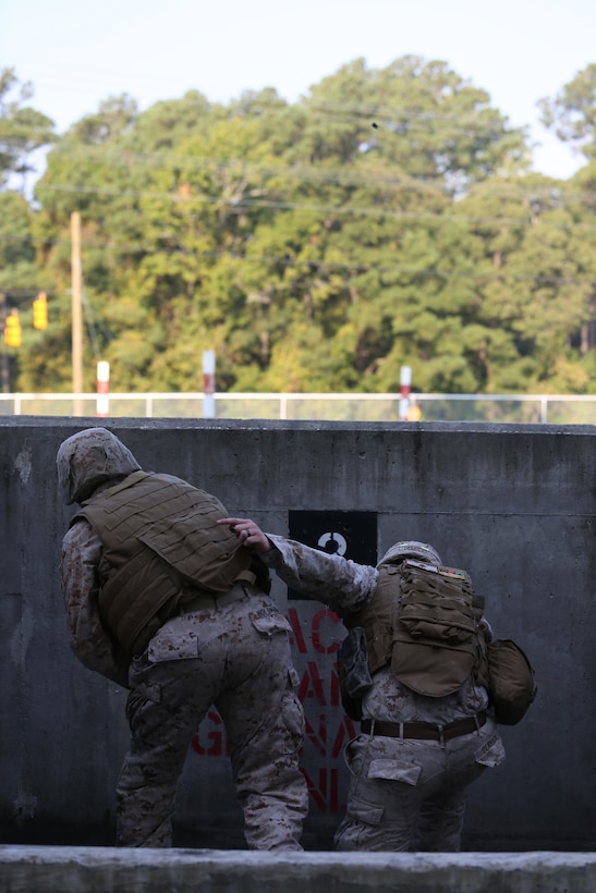 Sgt. Christopher A. Derrick, the operations non-commissioned officer for Bridge Company, 8th Engineer Support Battalion, 2nd Marine Logistics Group, pulls another Marine with the unit to safety after an M-69 training grenade is thrown downrange aboard Camp Lejeune, N.C., Sept. 10, 2013. Marines with the company practiced grenade-throwing procedures to keep the service members up to date on a variety of weapon systems. 