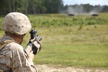 First Lt. Cullen G. Tores, a platoon commander with Bridge Company, 8th Engineer Support Battalion, 2nd Marine Logistics Group, sights in on a target with an M-32 Multiple Grenade Launcher downrange as part of a grenade training exercise aboard Camp Lejeune, N.C., Sept. 17, 2013. The exercise allowed Marines to train on weapon systems they may utilize during a deployment to a combat zone. 
