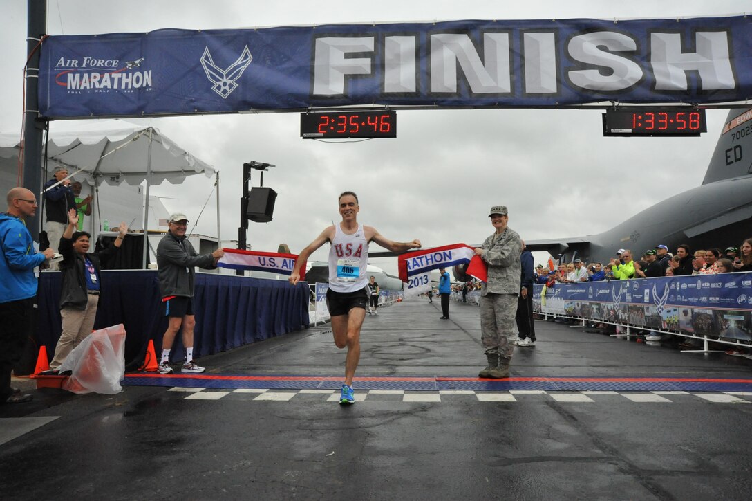 James Beyer, 46, of Dayton, Ohio, crosses the finish line to win the U.S. Air Force Marathon's men's full marathon event at 2:35:47, Sept. 21, 2013, at Wright-Patterson Air Force Base, Ohio. (U.S. Air Force photo/Michelle Gigante)
