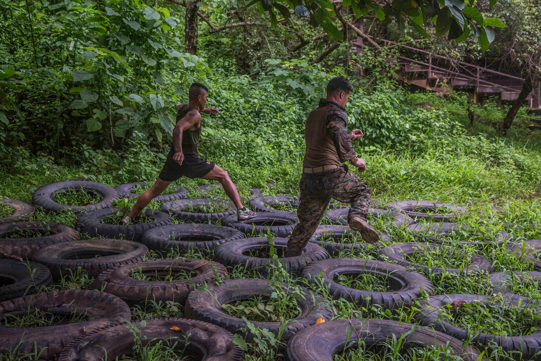 U.S. and Philippine Marines run through a jungle obstacle course during Amphibious Landing Exercise 2014 (PHIBLEX 14) at Marine Barracks Gregorio Lim, Ternate, Cavite, Republic of the Philippines, Sept. 18, 2013. PHIBLEX is a bilateral training exercise that demonstrates the commitment of the United States and Republic of the Philippines to mutual security and their long-term partnership. It also ensures the readiness of a bilateral force to rapidly respond to regional humanitarian crises. The U.S. Marines are with Force Reconnaissance Platoon, Maritime Raid Force, 13th Marine Expeditionary Unit. The Philippine Marines are with Force Reconnaissance Battalion. (U.S. Marine Corps photo by Sgt. Ammon W. Carter, 13th Marine Expeditionary Unit Combat Camera/Released)