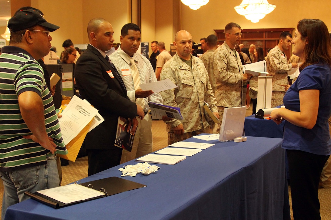 Service members browse through booths at the Hiring our Heroes job fair at the Pacific Views Event Center here Sept. 19. The fair was held to help service members who are transitioning back into civilian life find work.